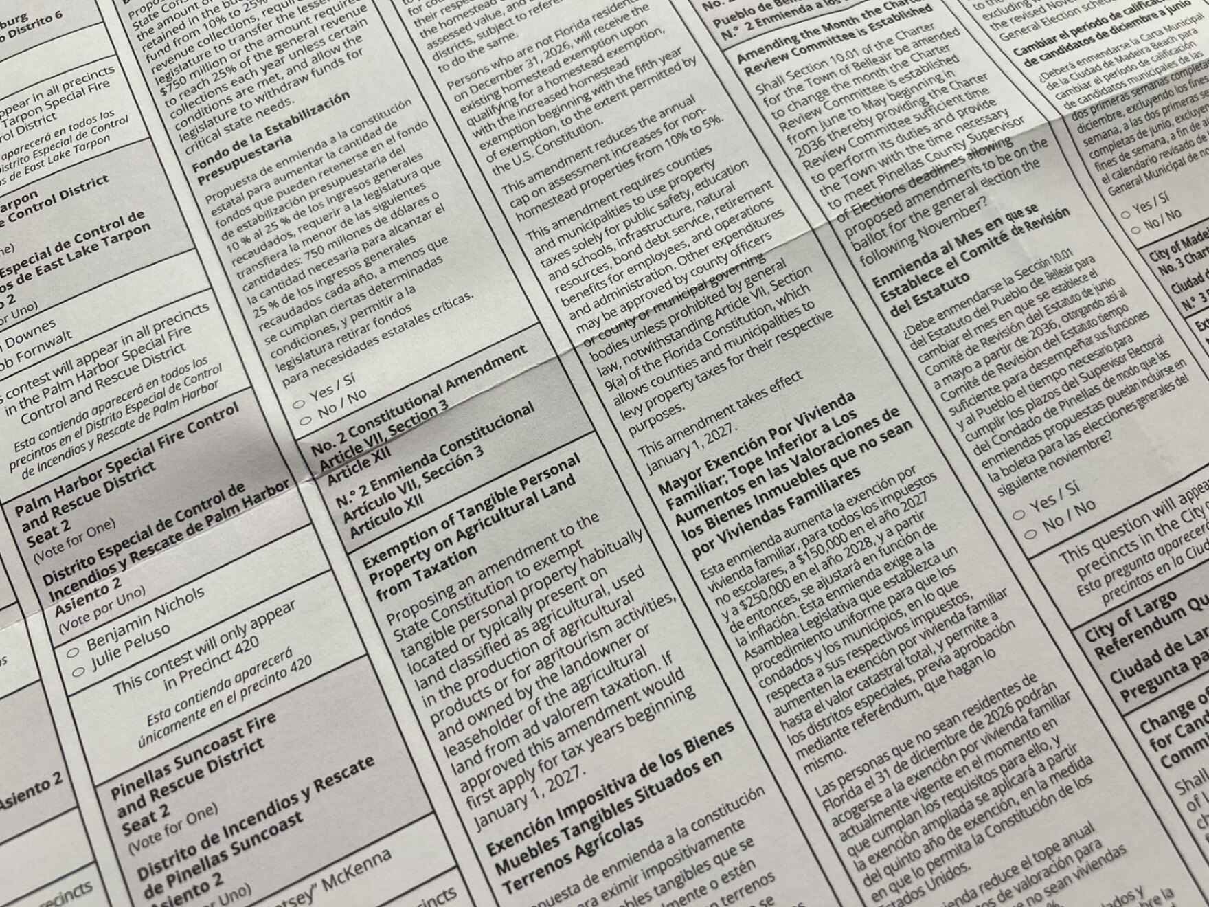 Close-up of a printed election ballot with English and Spanish text showing multiple races.