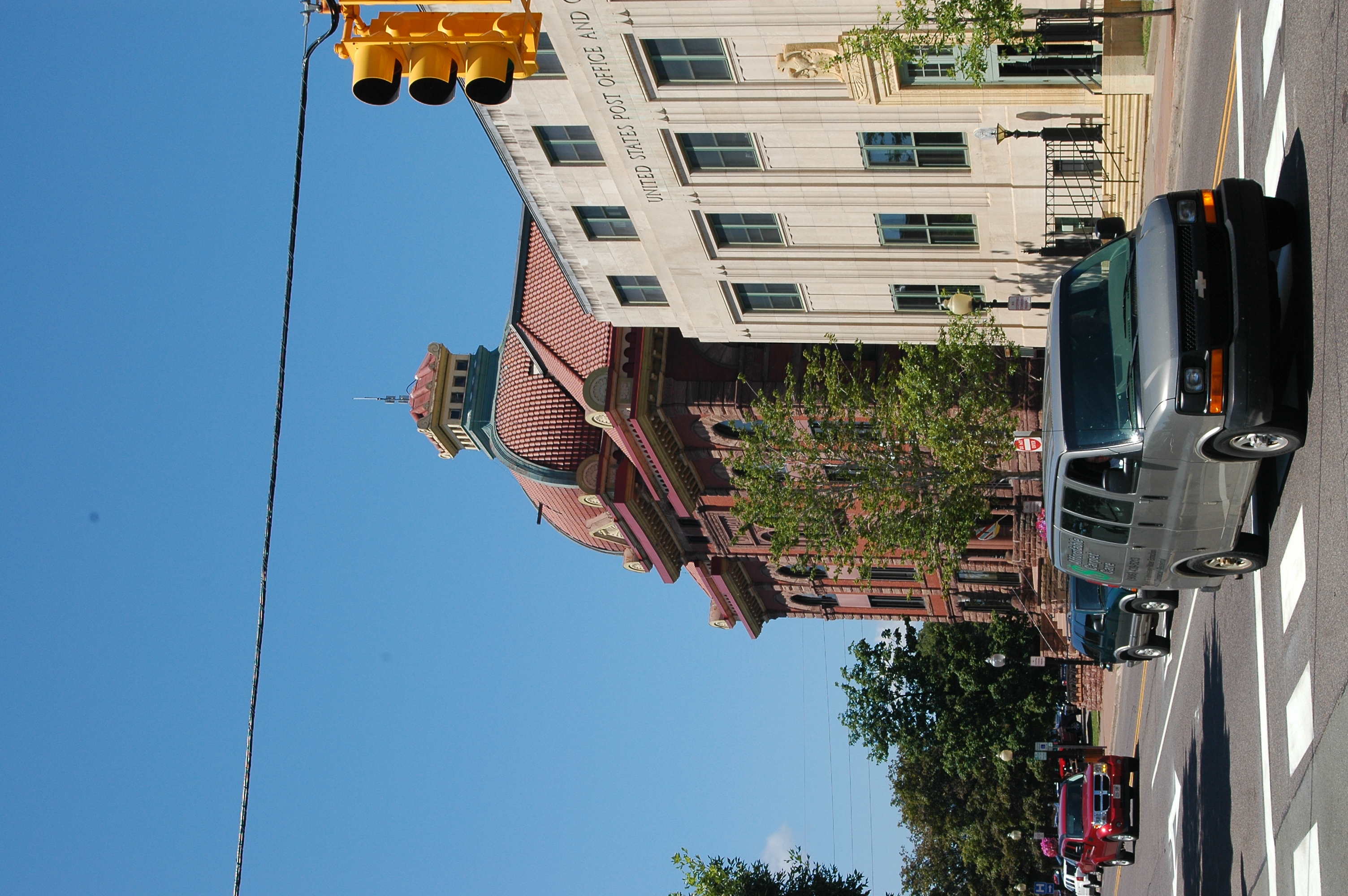 Historic brick building with copper dome at a downtown Marquette, Michigan street corner.