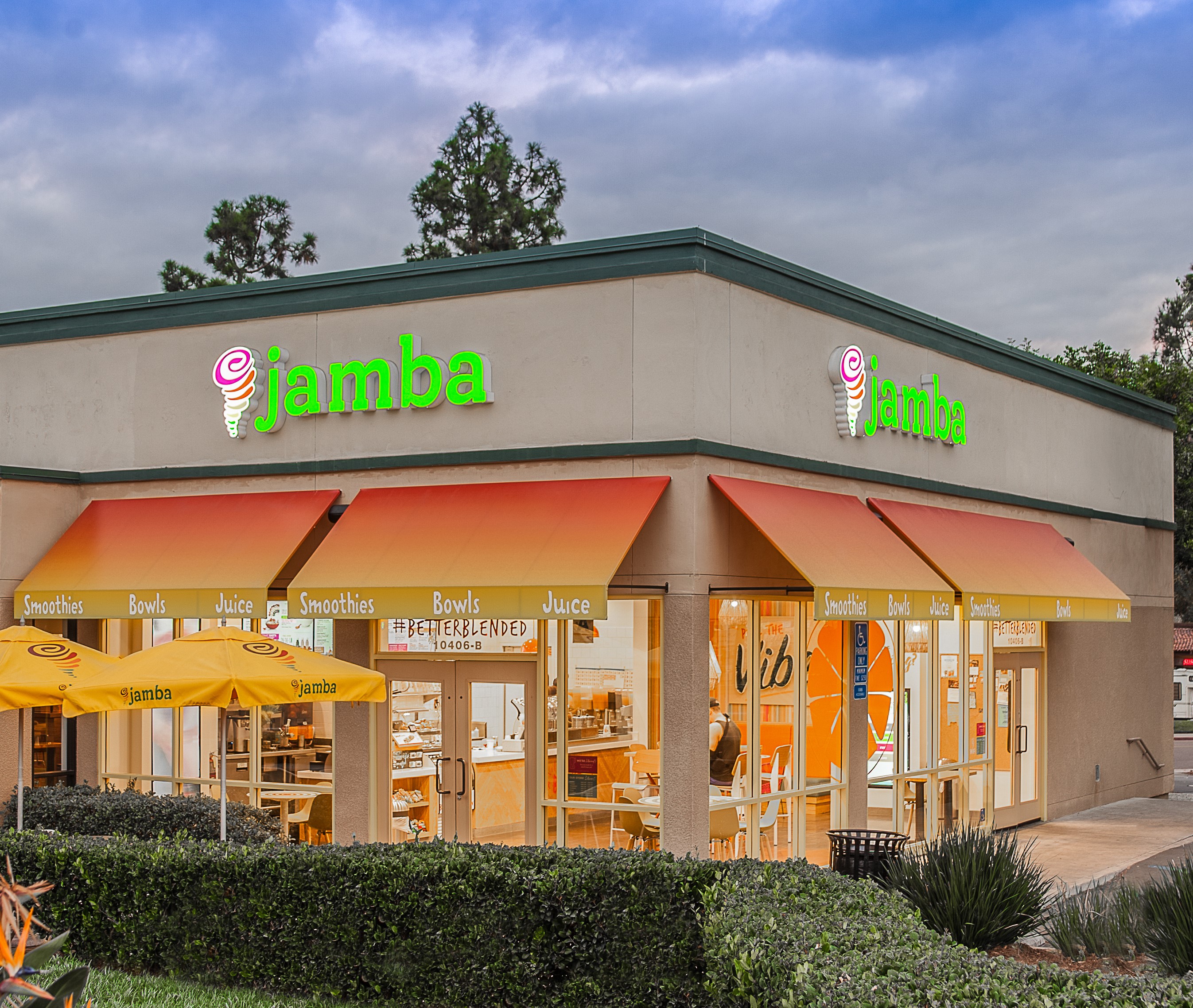 Exterior of a Jamba store with green lettering and orange-yellow awnings.