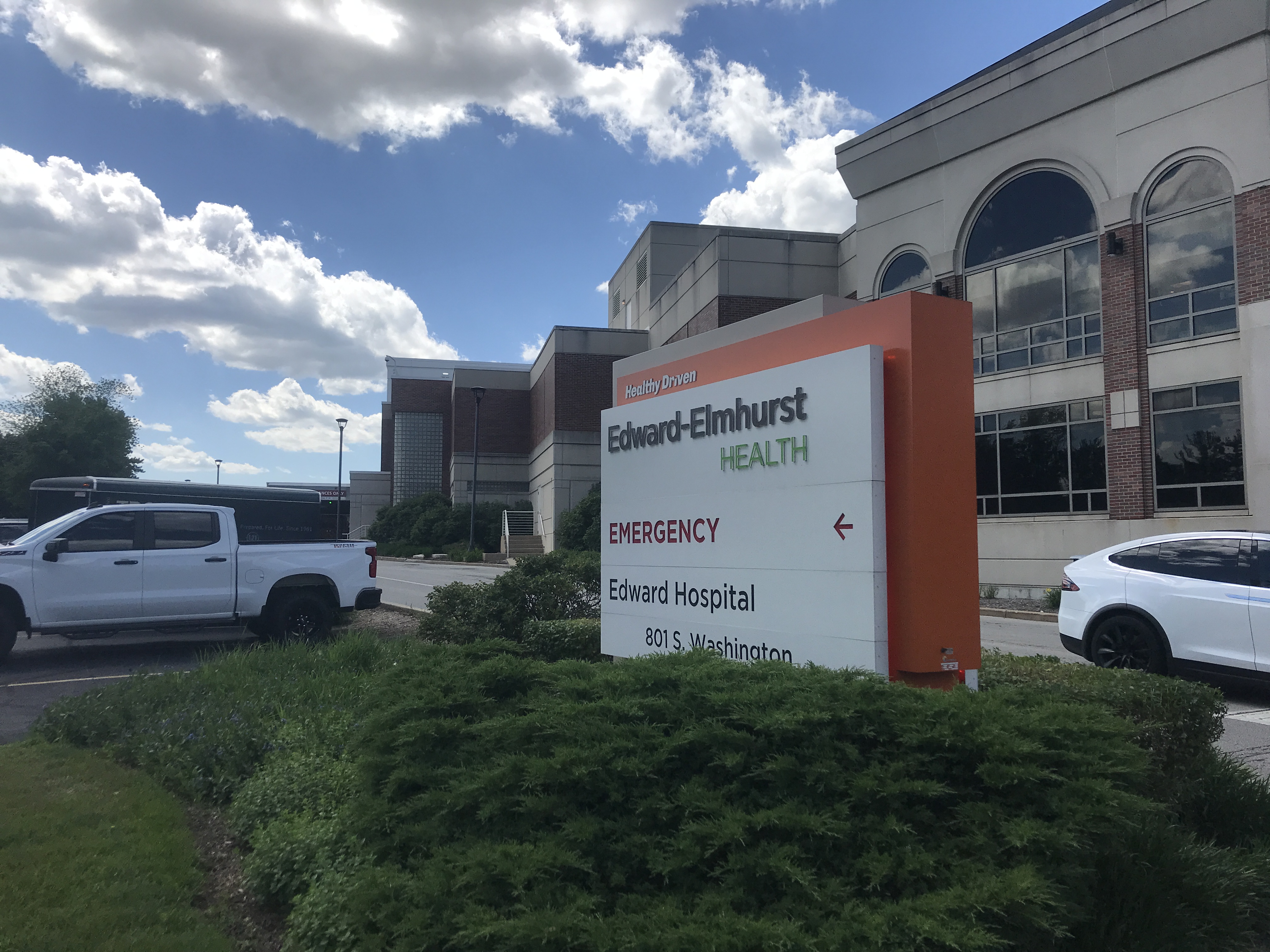 Exterior sign reading Edward-Elmhurst Health with an emergency arrow and hospital address.