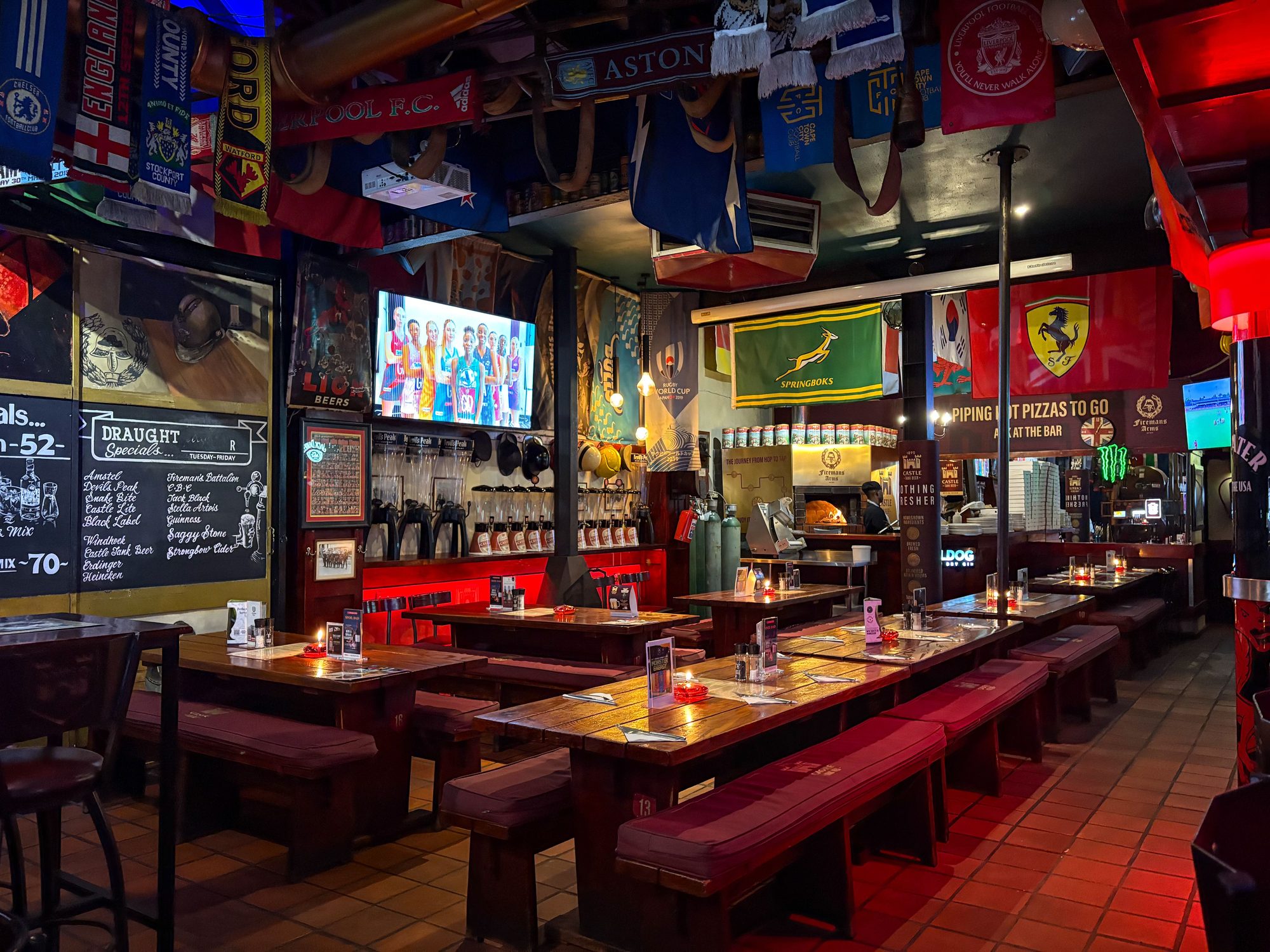 Colorful sports bar with flags and memorabilia in Cape Town, ideal for social gatherings.