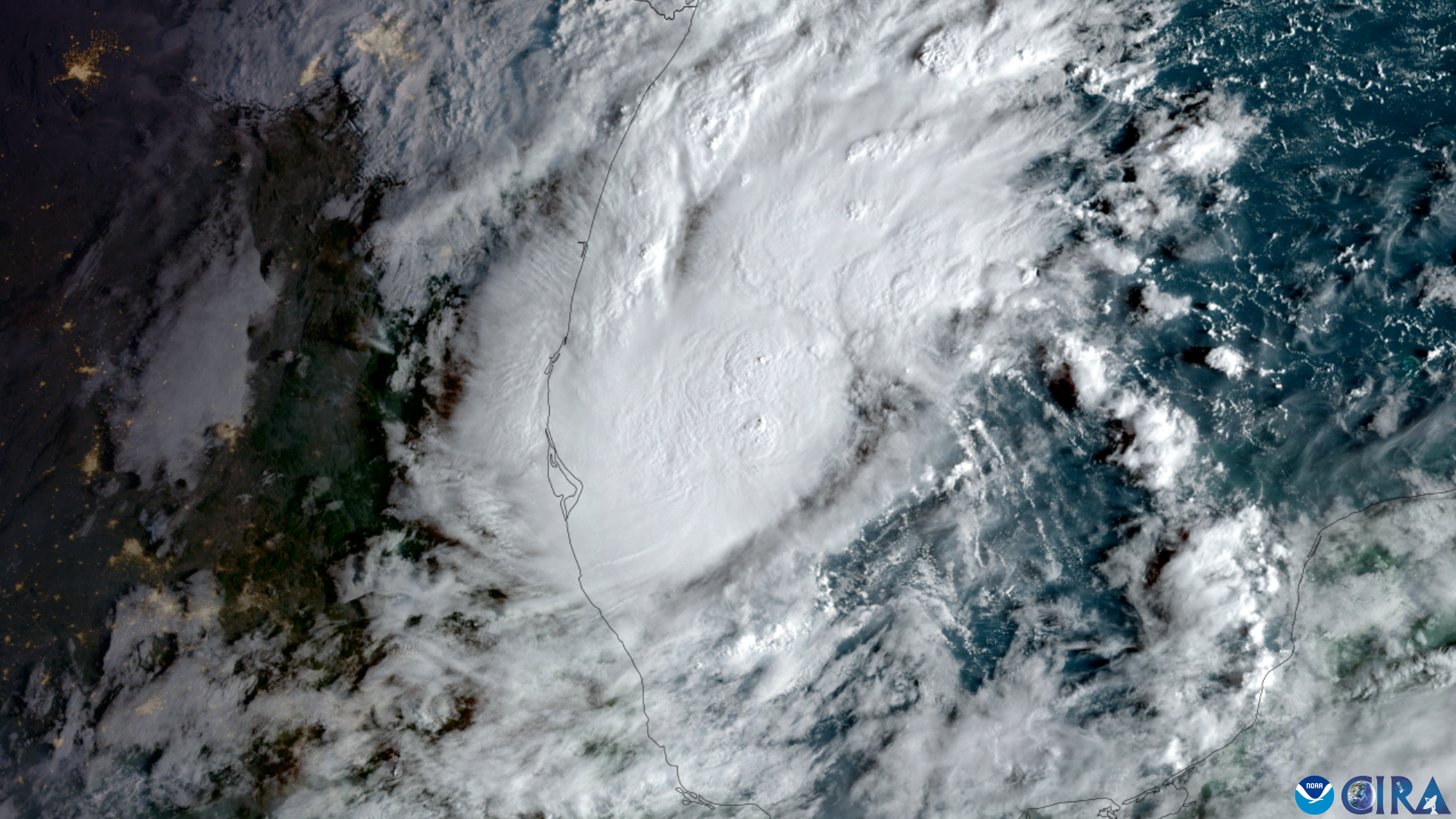 Satellite view of a tropical storm with a defined eye and spiral bands over the Gulf of Mexico.