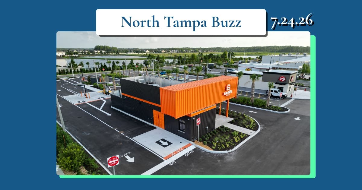 Aerial view of a compact orange drive-thru restaurant building in a parking lot.