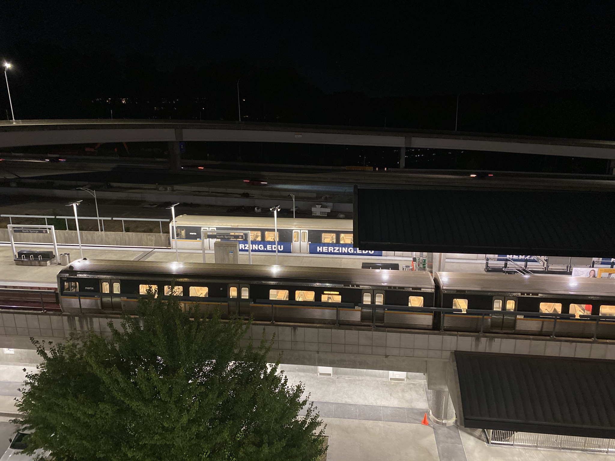 A MARTA train stopped at an illuminated station platform at night.
