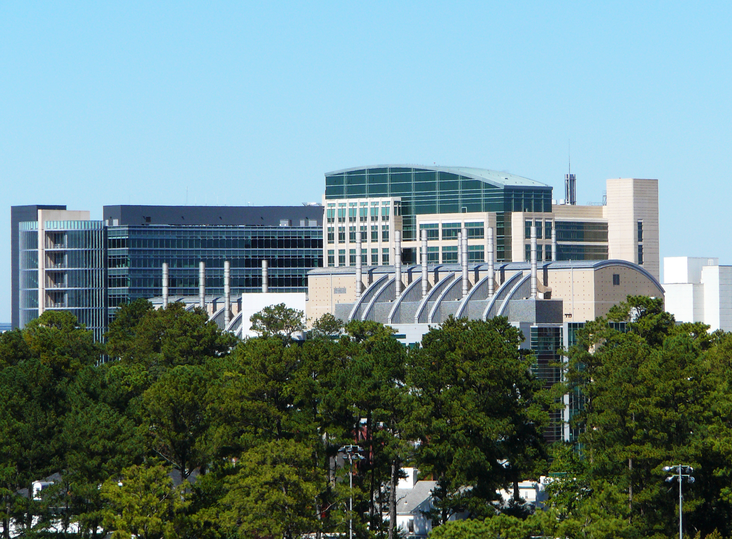 Large modern glass and concrete buildings of the CDC campus under a blue sky.