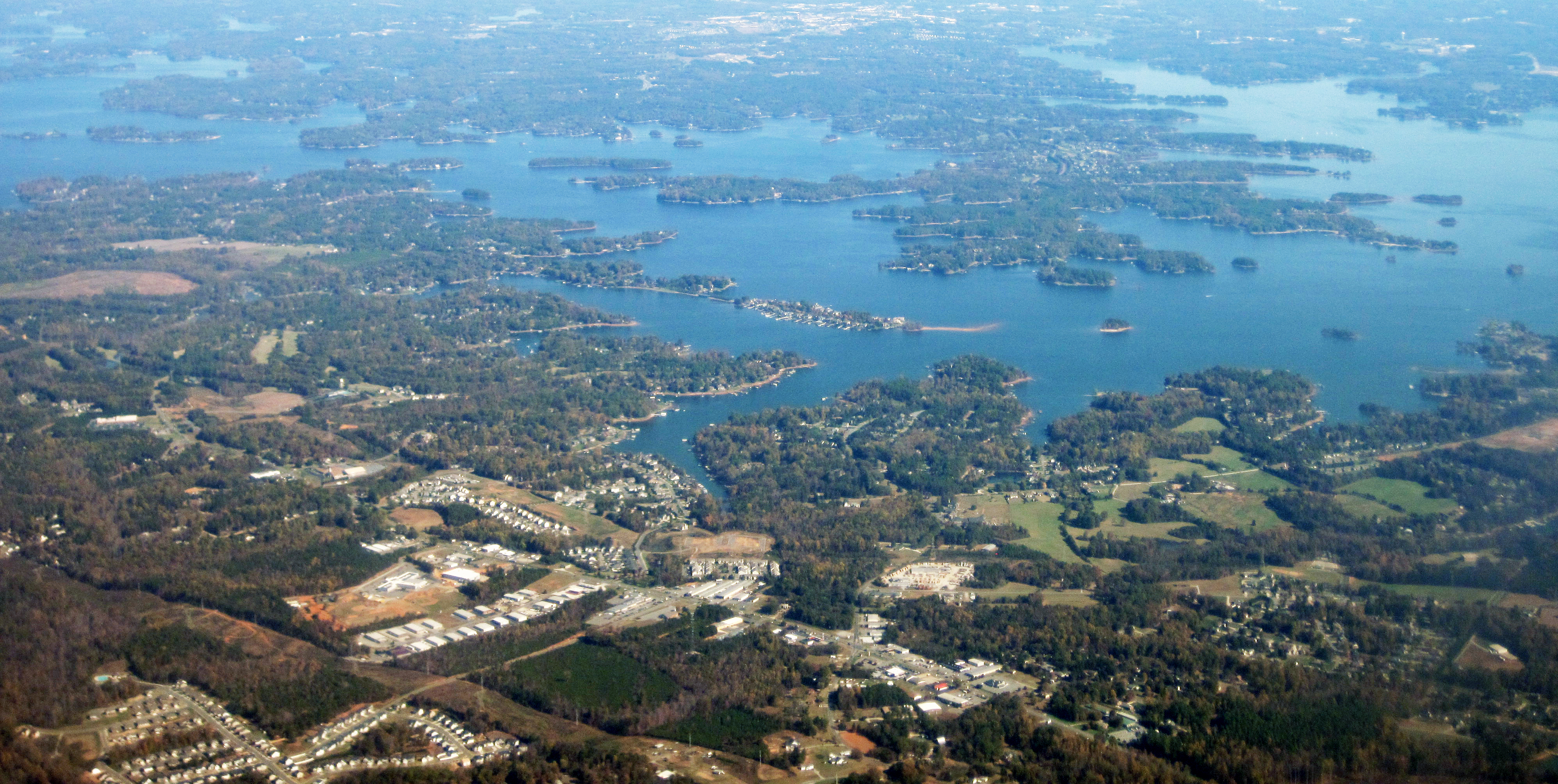 Aerial view of a large reservoir with coves, peninsulas, and residential development along the shoreline.