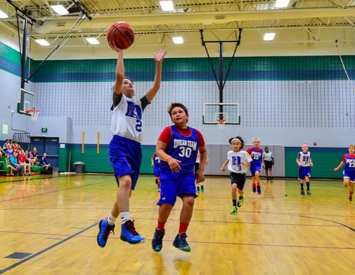 Youth boys basketball team playing on the court