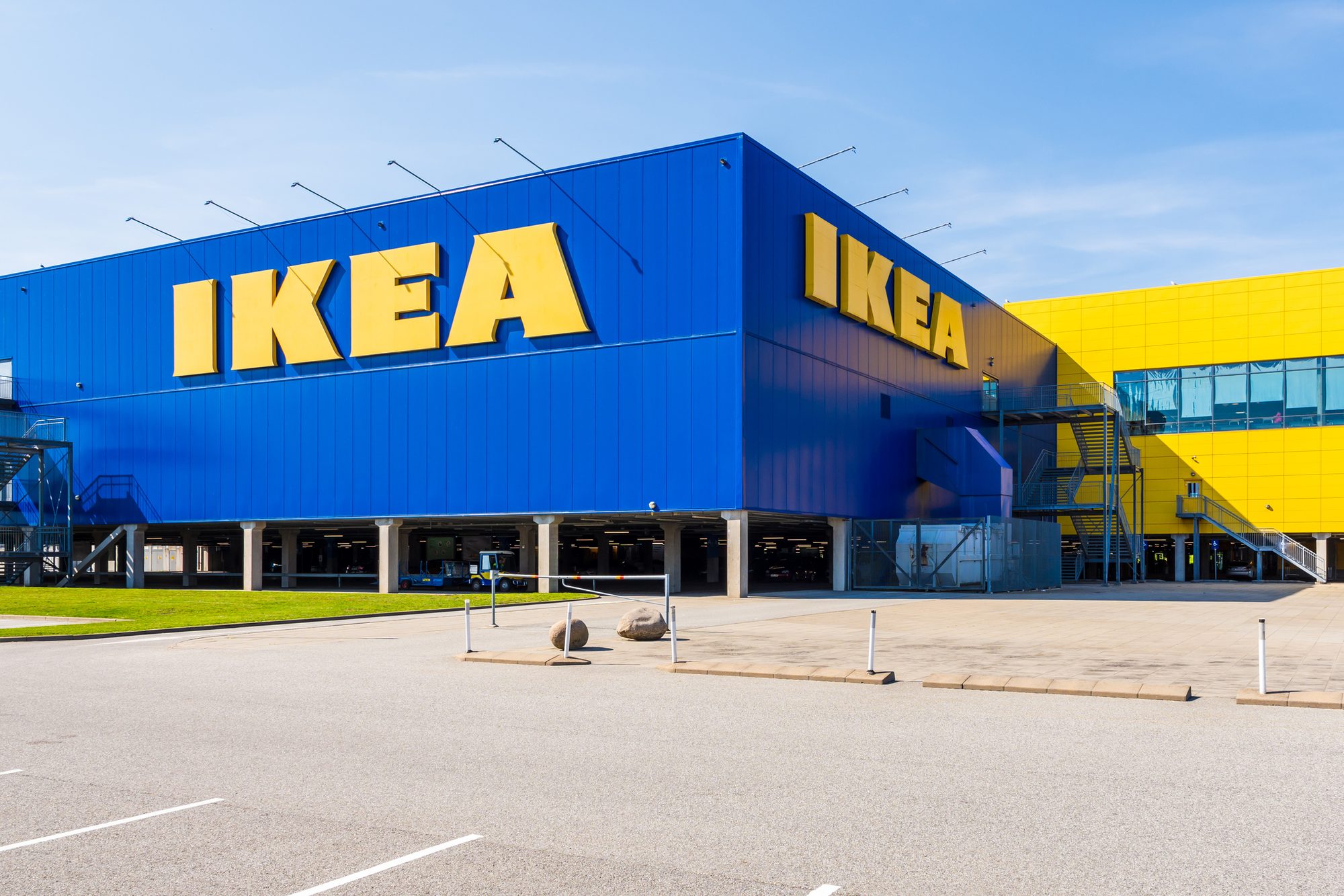 Large IKEA signs on the blue facade of an IKEA store.