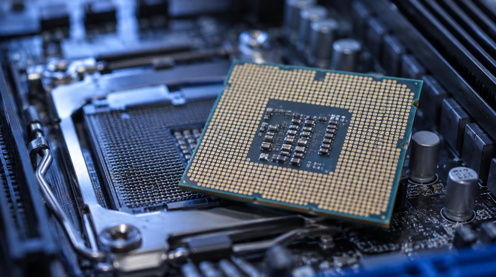 Close-up of a server processor chip on a circuit board with gold pins.