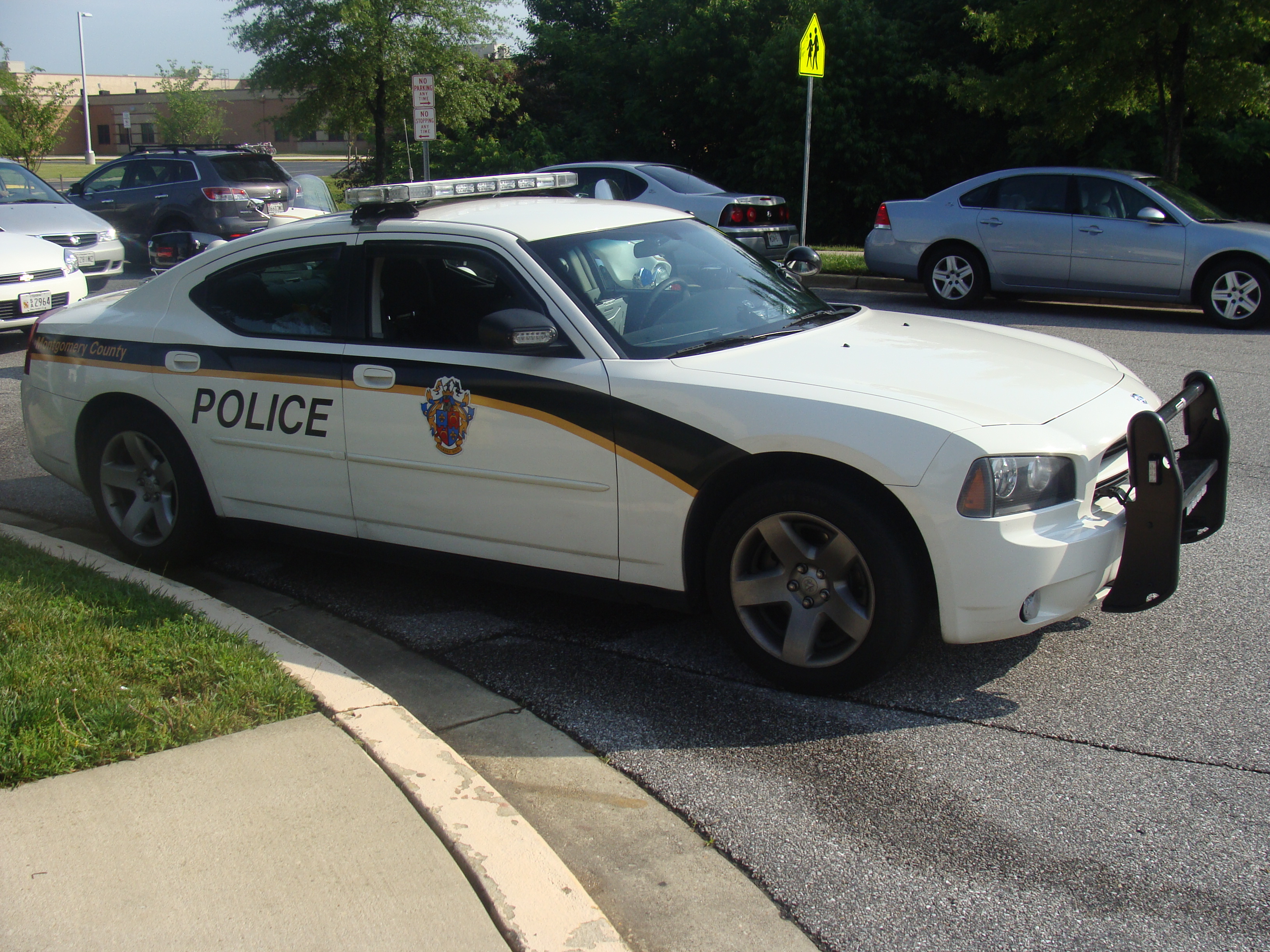 A white Dodge Charger police cruiser with Montgomery County Police Department markings.