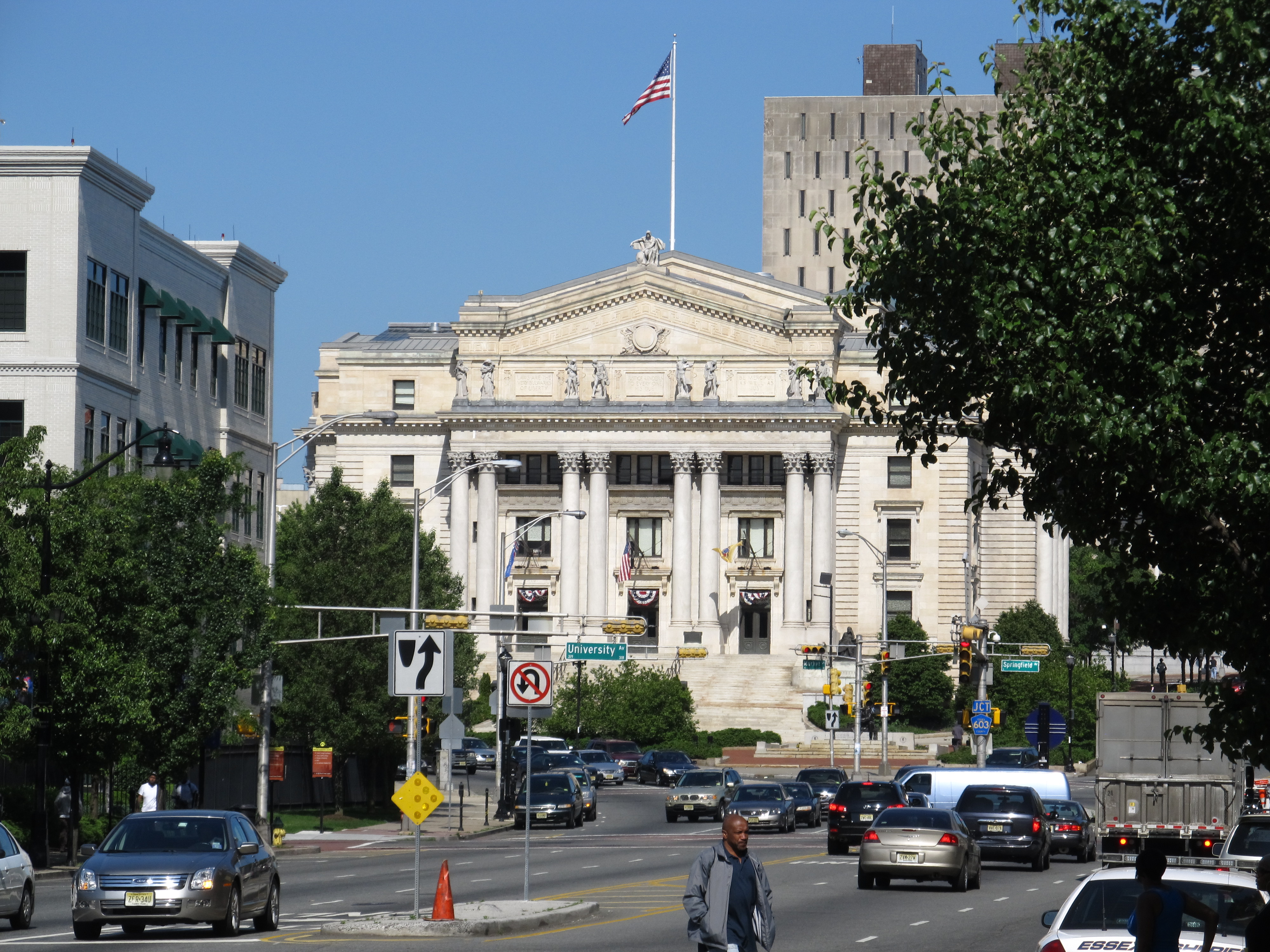 Neoclassical courthouse building with columns, pediment, and a U.S. flag atop.