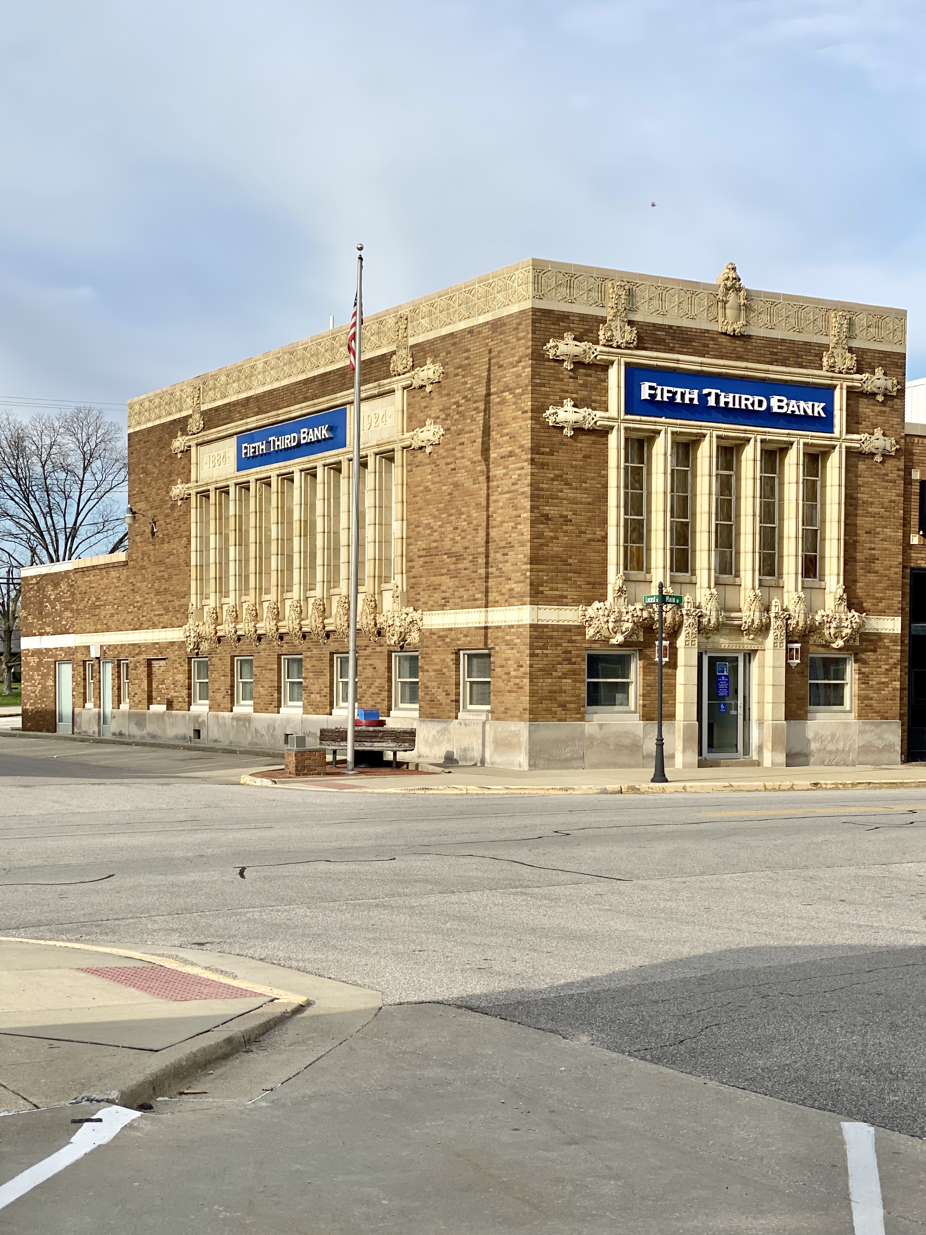 Historic brick bank building on a street corner with a blue Fifth Third Bank sign.