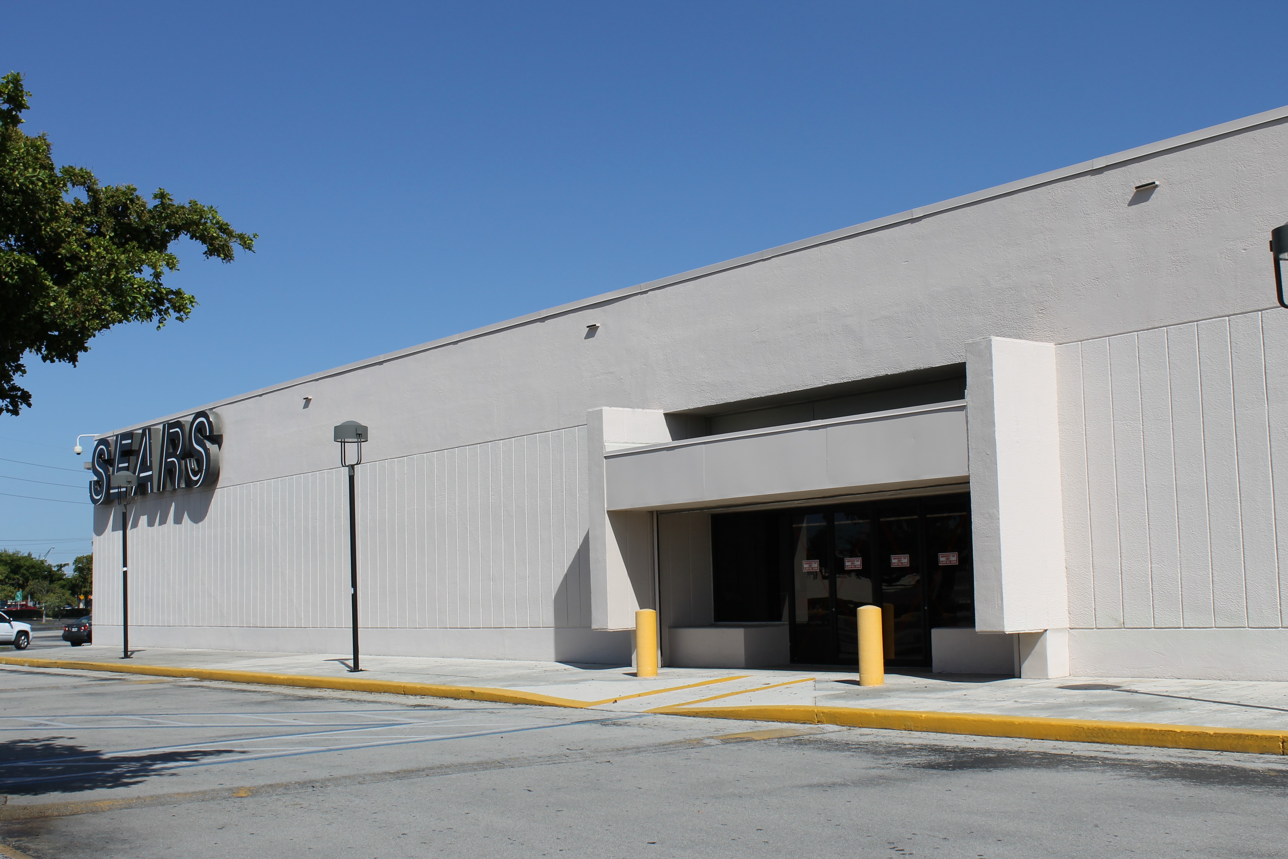 Exterior of a closed Sears store with empty parking lot at Southland Mall in Cutler Bay.