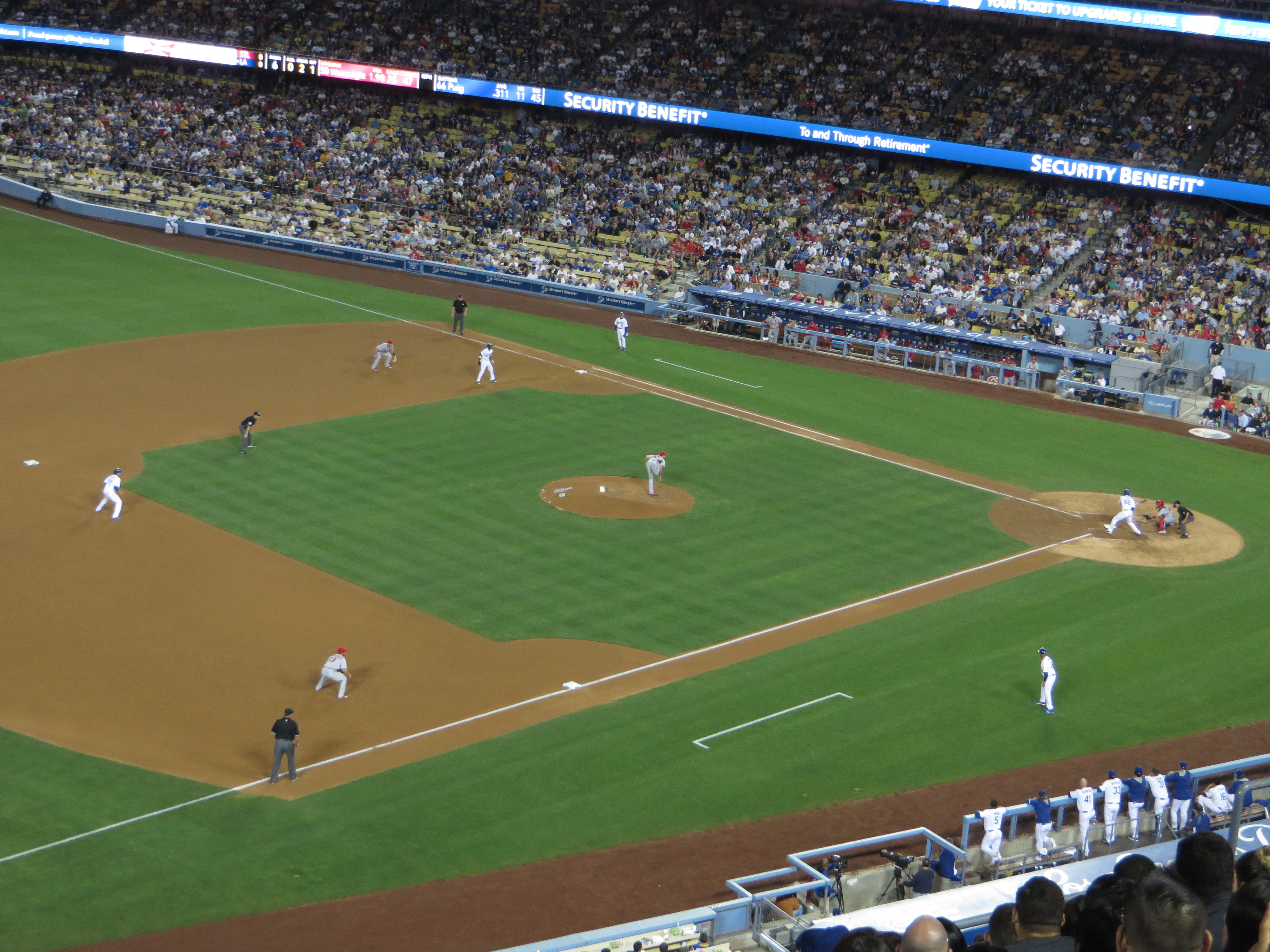 Aerial view of a baseball game in progress at Dodger Stadium with a packed crowd.