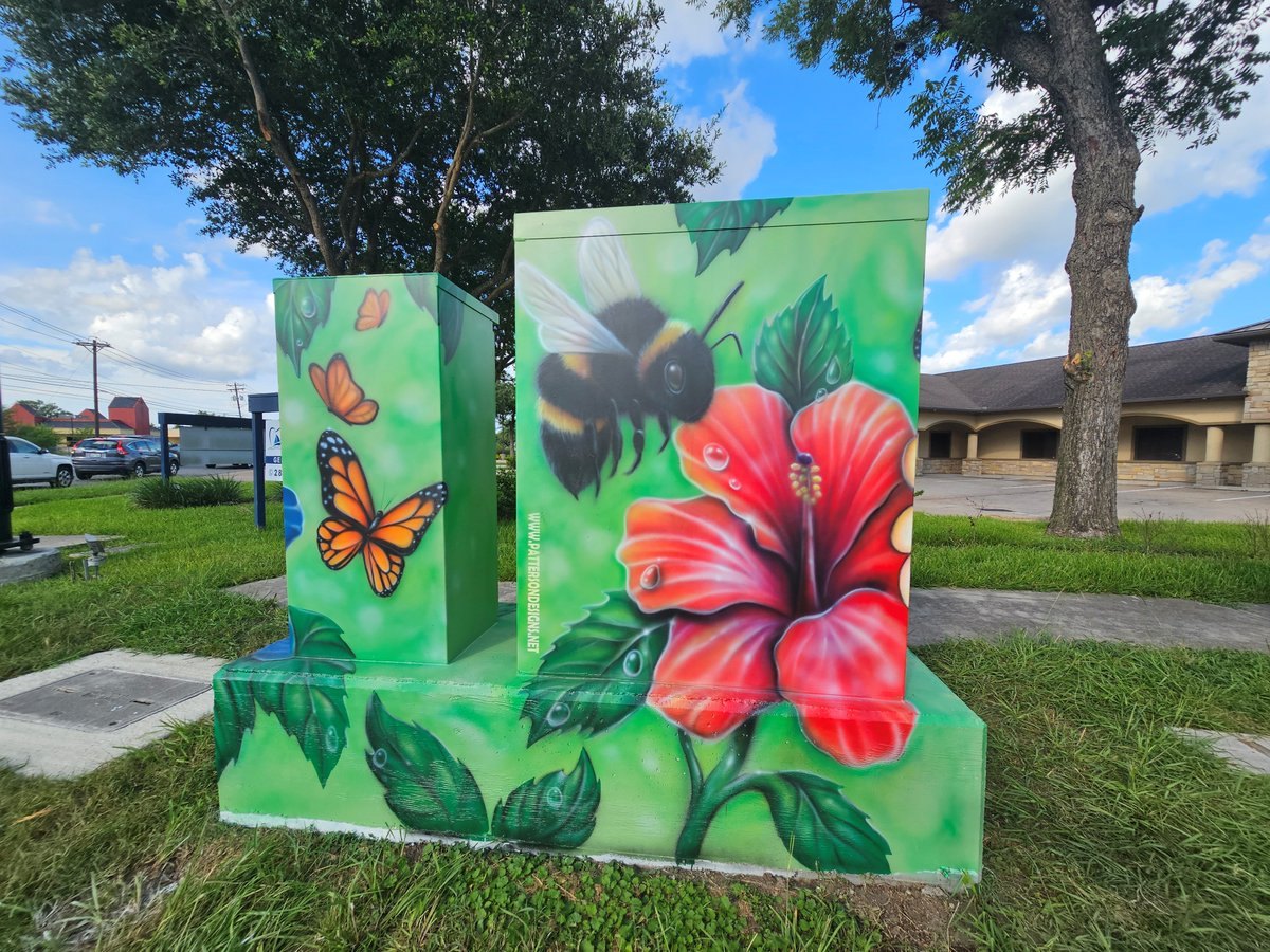 Painted traffic utility box with colorful mural of a bumblebee, butterfly, and flowers.