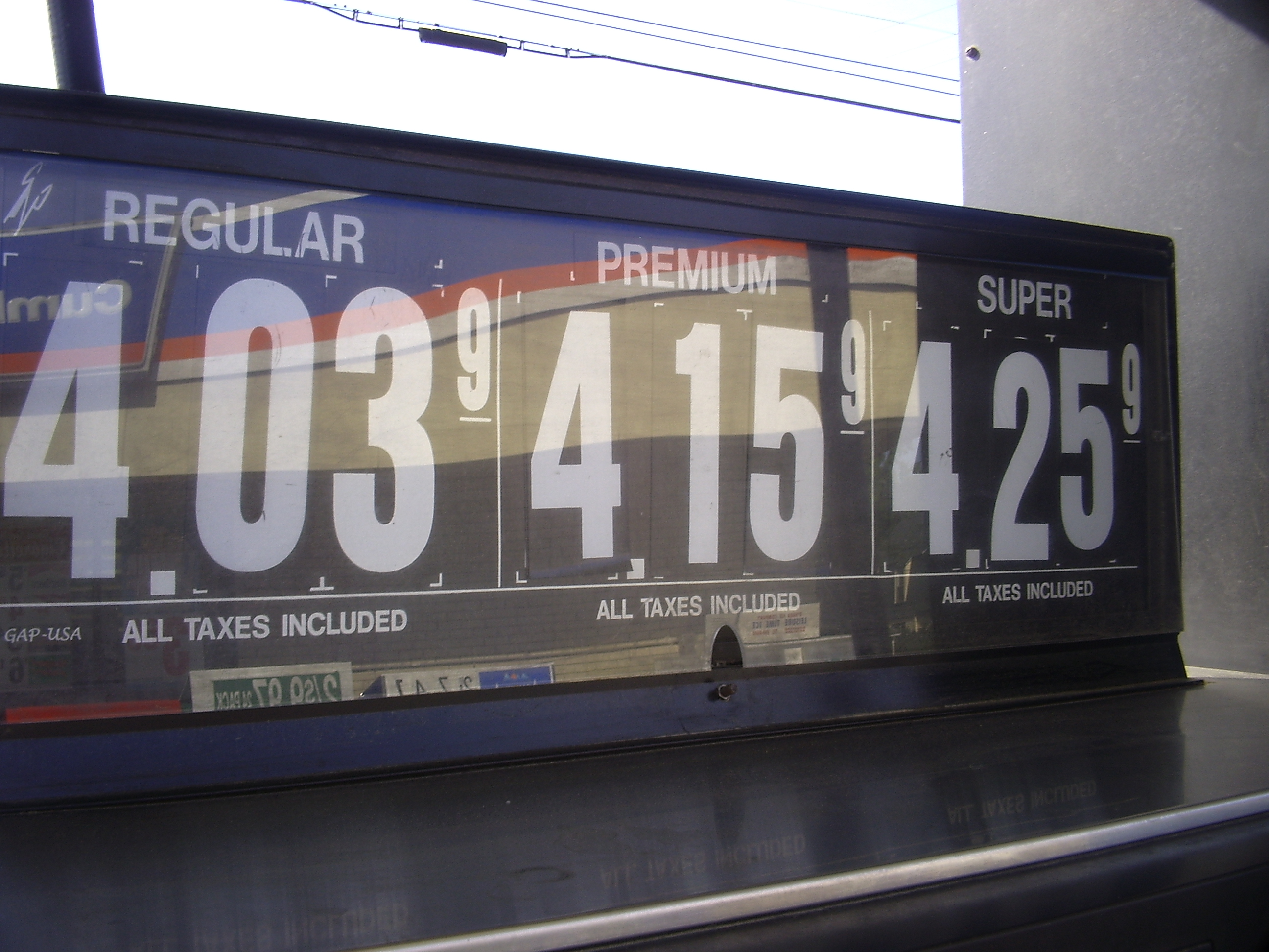 Gas station price sign displaying fuel grades priced above four dollars per gallon.