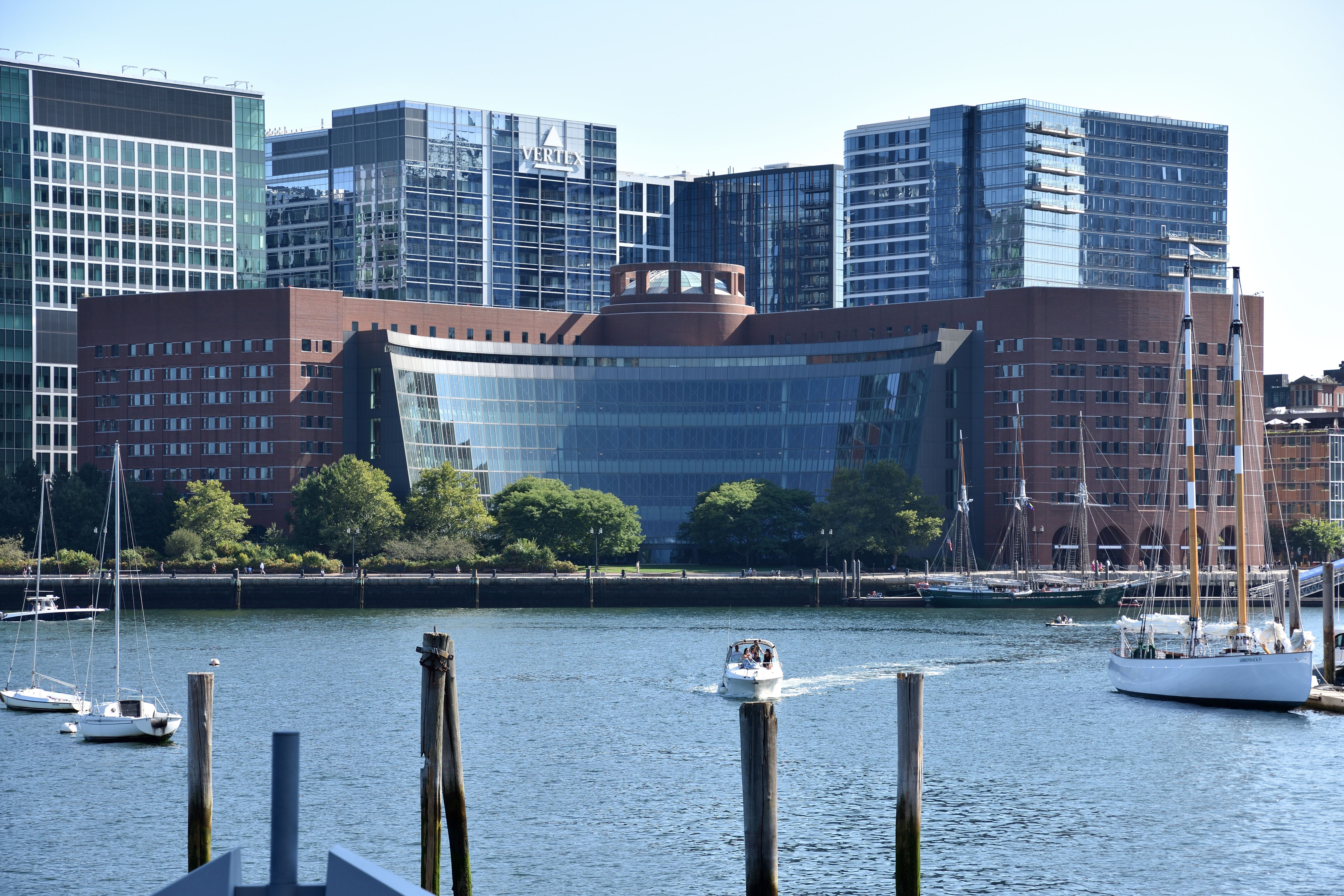 Federal courthouse building on a waterfront with sailboats in the foreground.