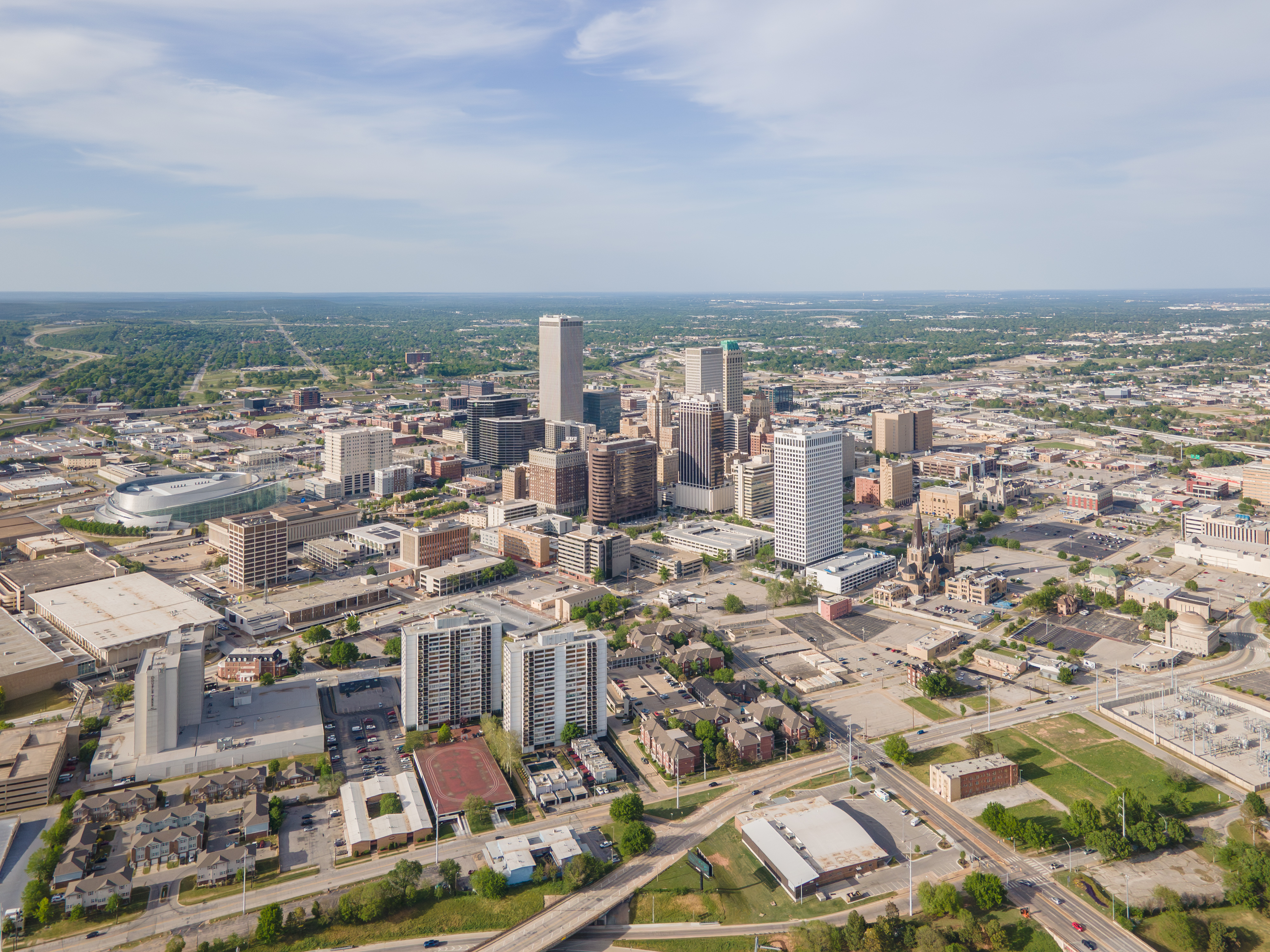 Aerial view of a city skyline with high-rise buildings and surrounding neighborhoods.