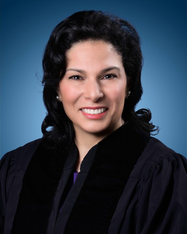 Judge Marilyn Zayas in front of a solid blue background.