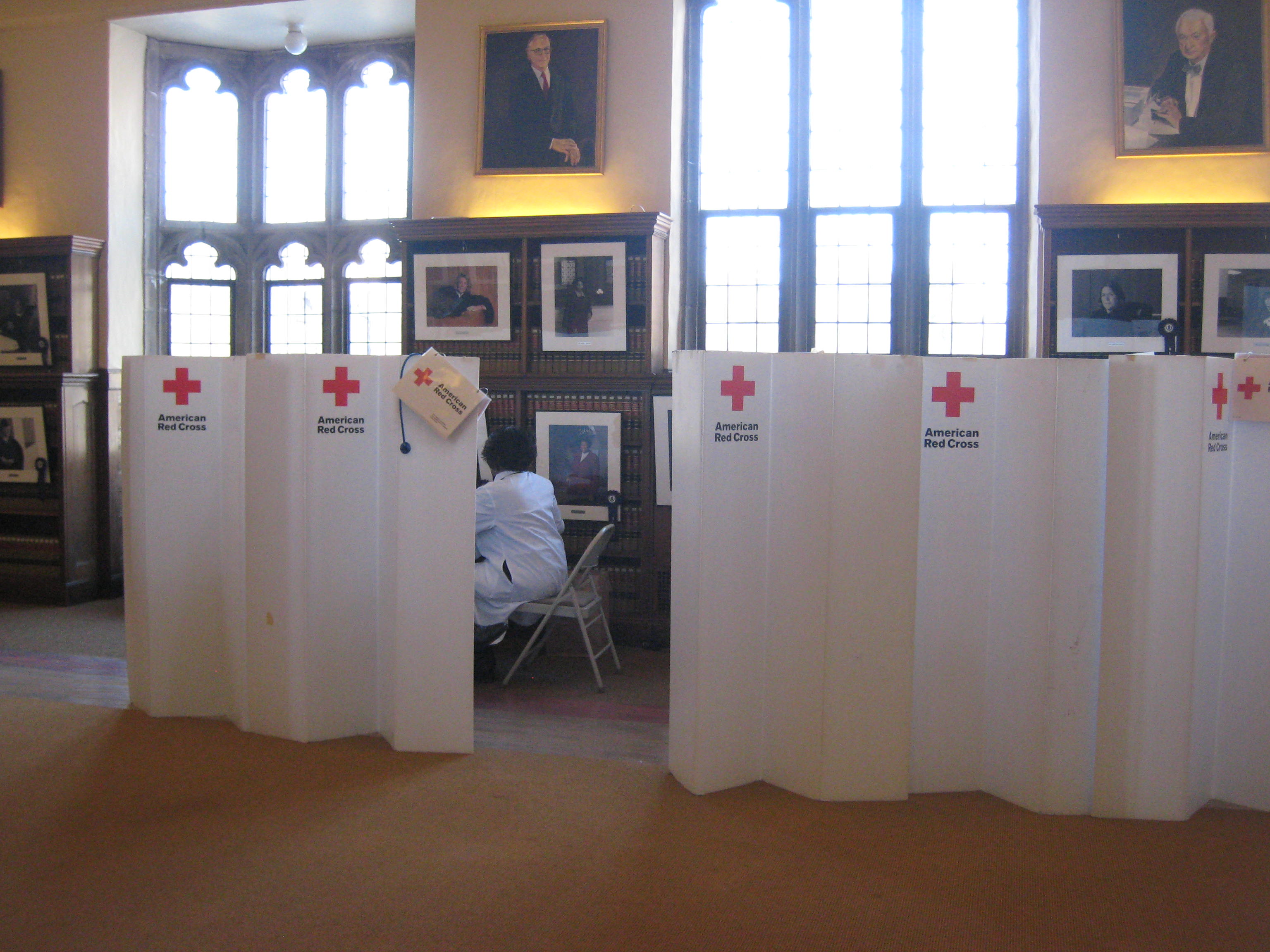 Rows of white American Red Cross privacy dividers set up in a room for a blood drive.