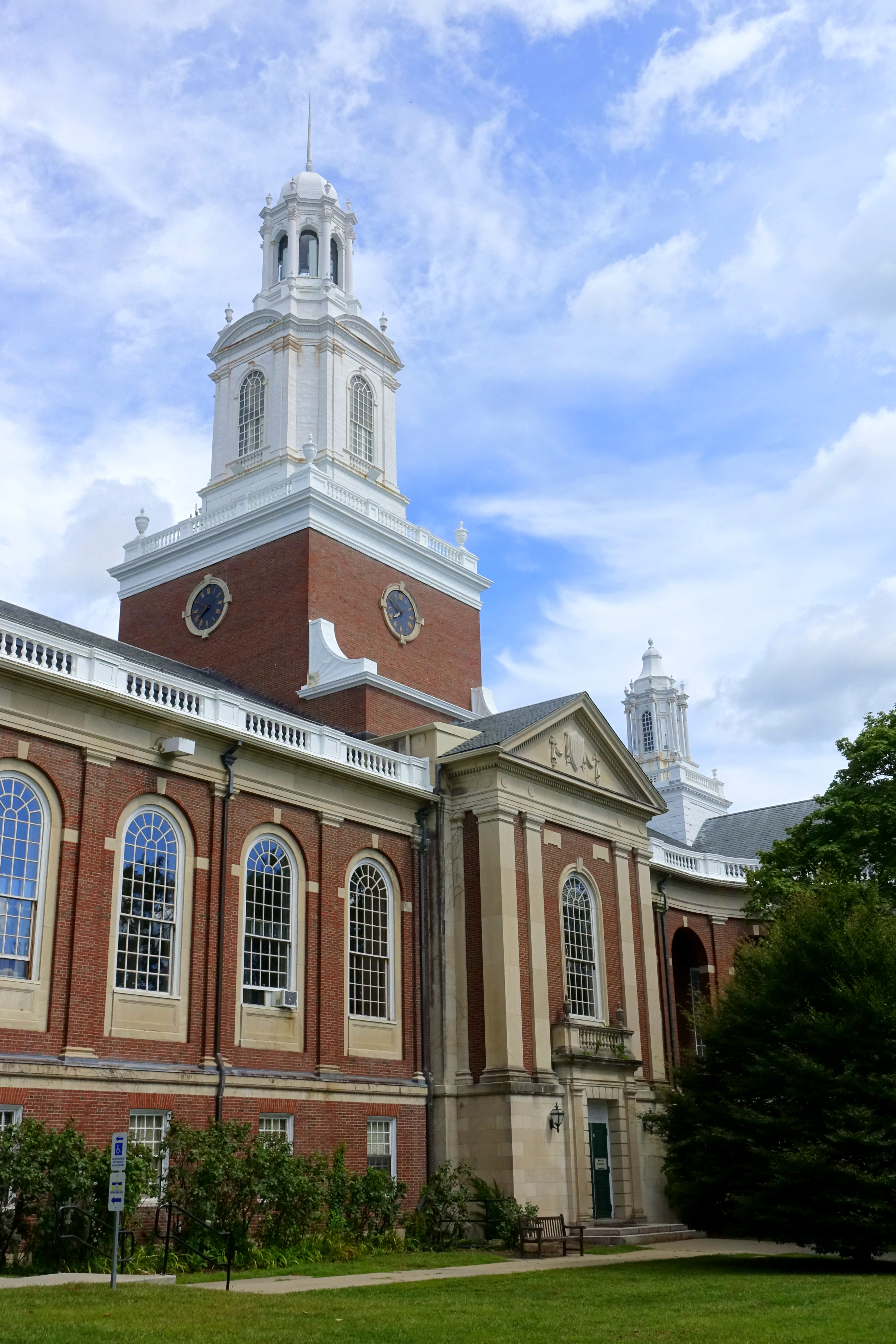 Red-brick Colonial Revival city hall building with white clock tower and cupola.