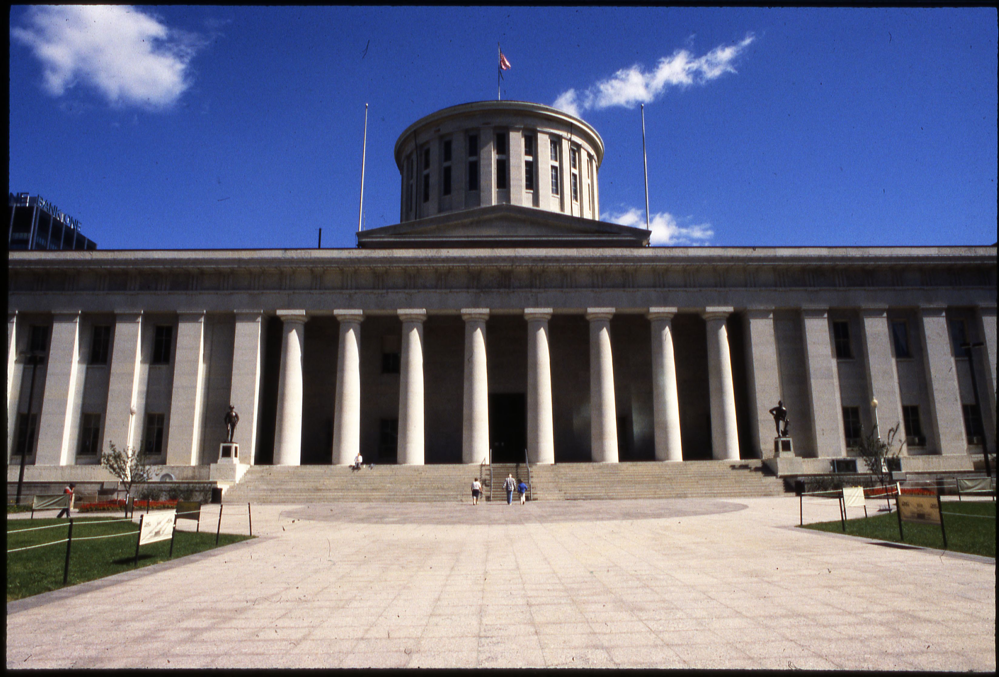 Greek Revival statehouse building with tall columns and wide stone steps.
