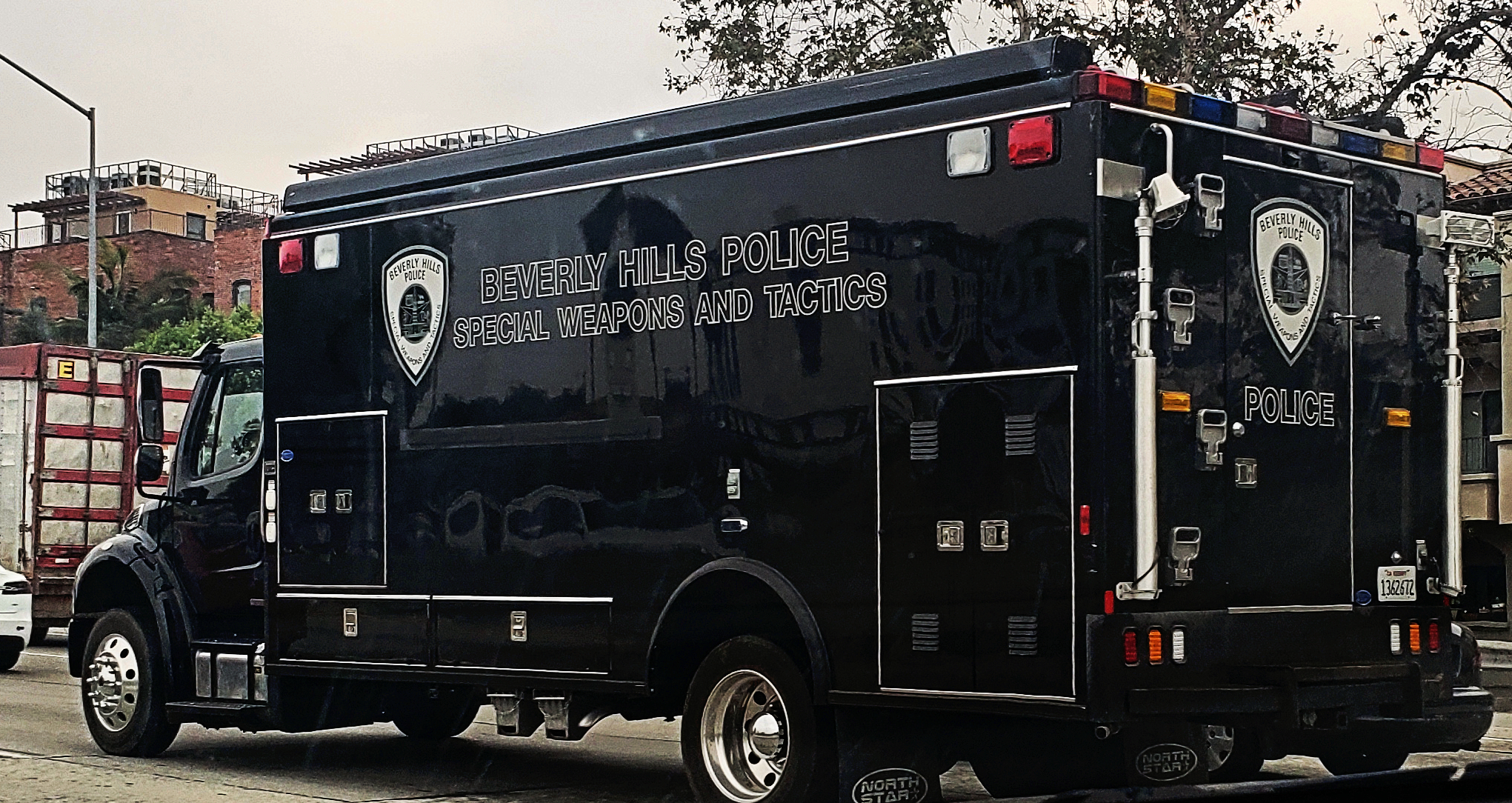 A large Beverly Hills Police Department SWAT vehicle on a freeway.