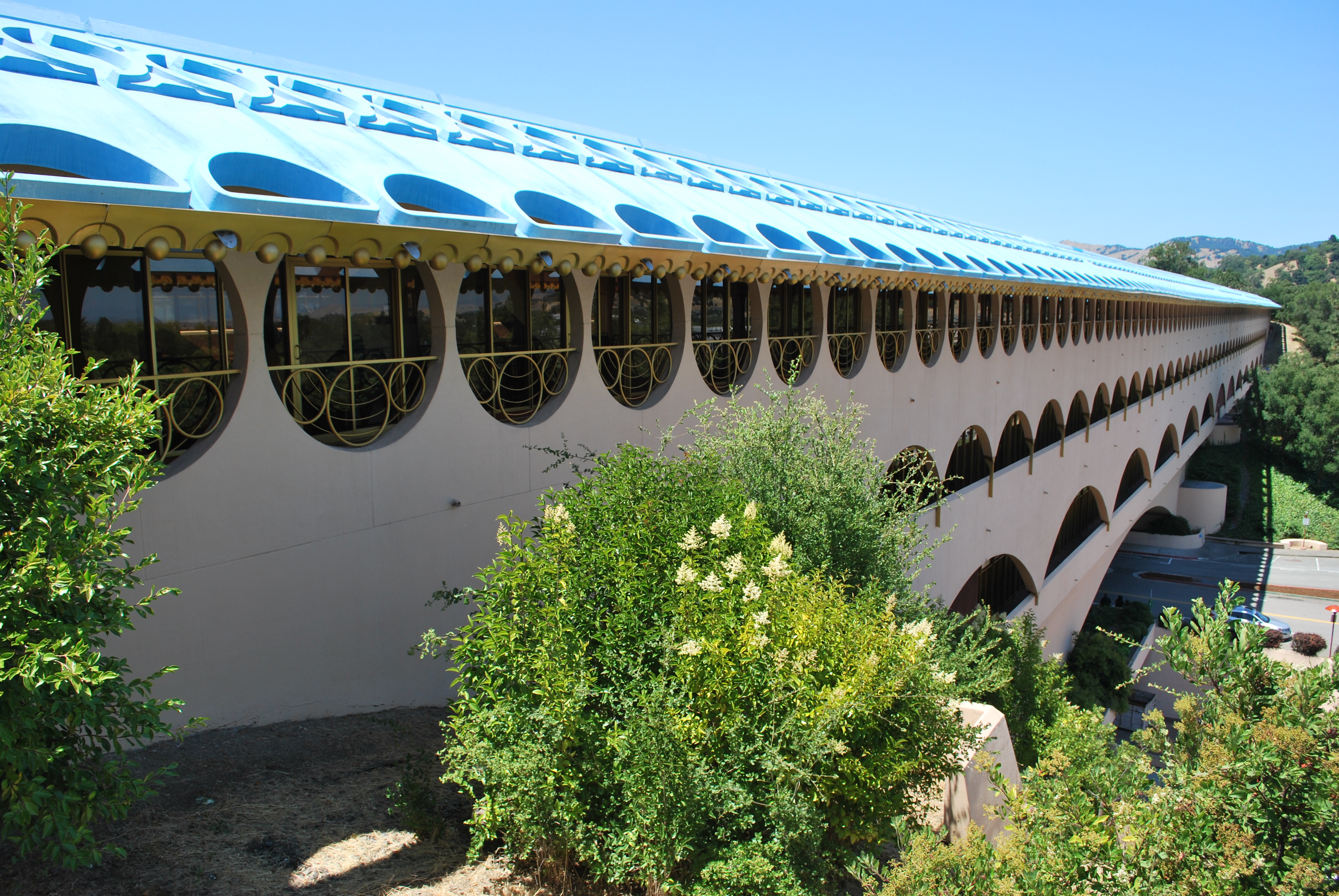 Exterior of the Marin Civic Center with a blue roof and arched windows.