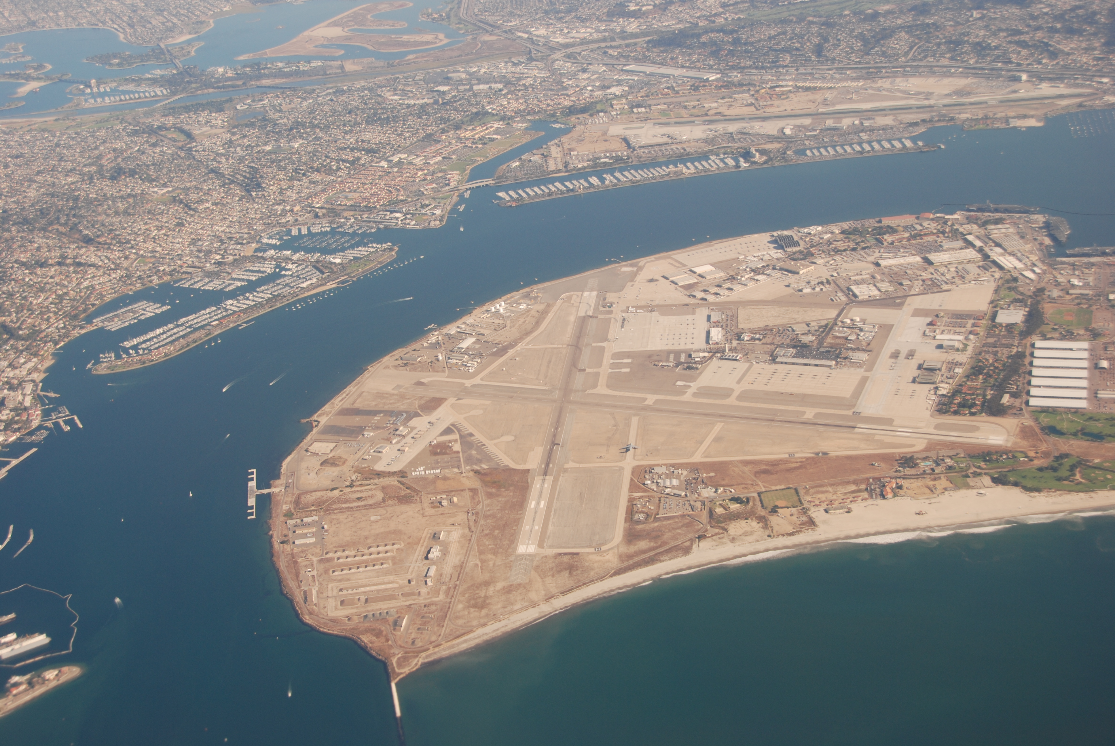 Aerial view of a naval air station on a coastal peninsula surrounded by blue water.