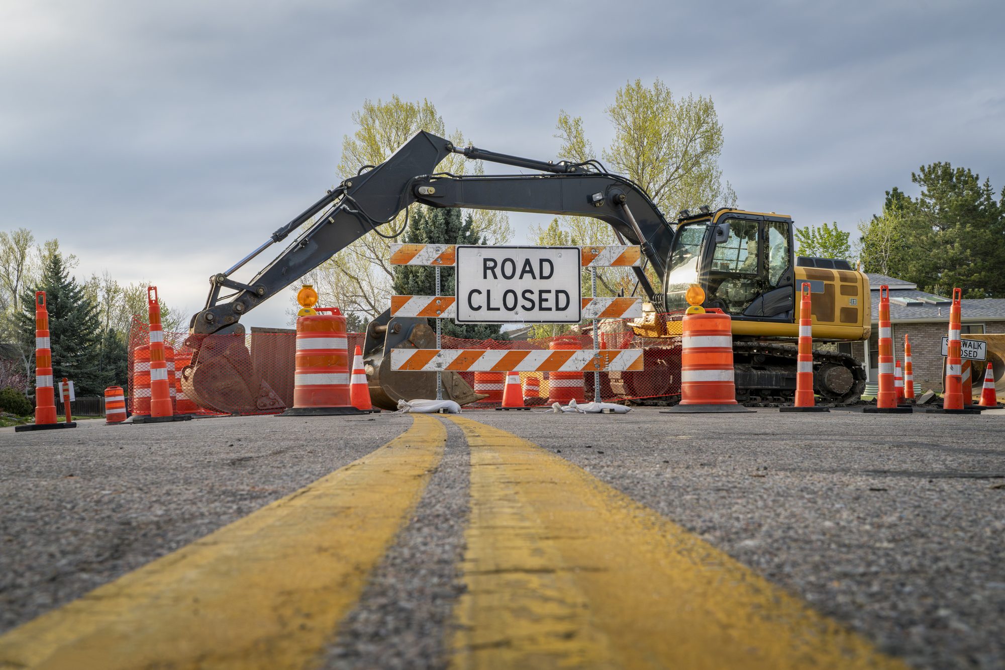 road closed - sign and barrier on a residential street for construction