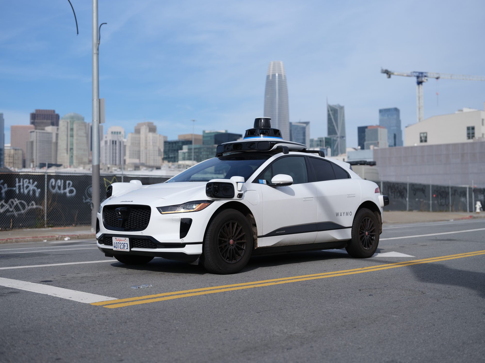 A Waymo-operated Jaguar I-Pace. The vehicle is operating autonomously without any person in the driver's seat.