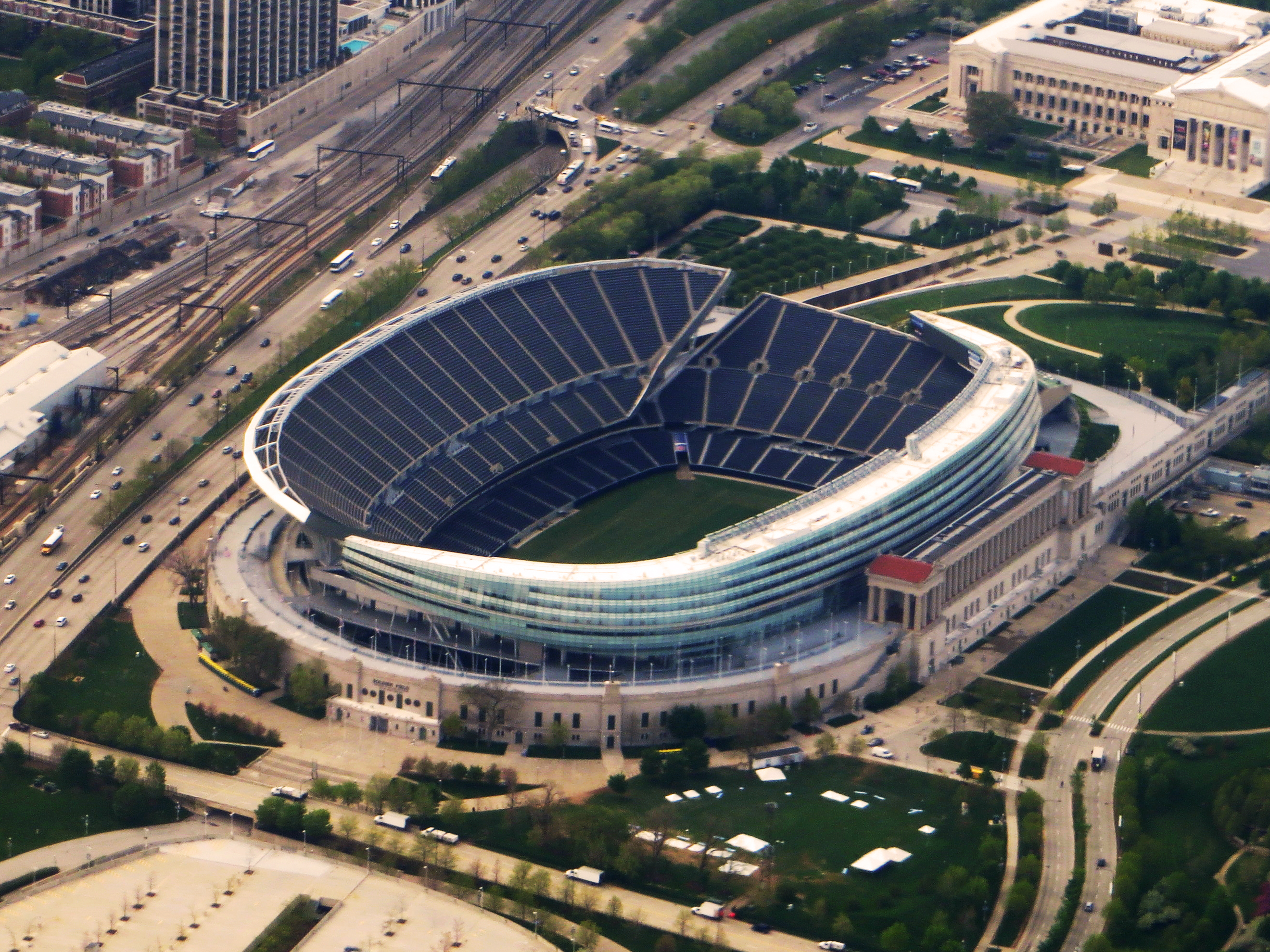 Aerial view of Soldier Field stadium surrounded by parkland in Chicago.