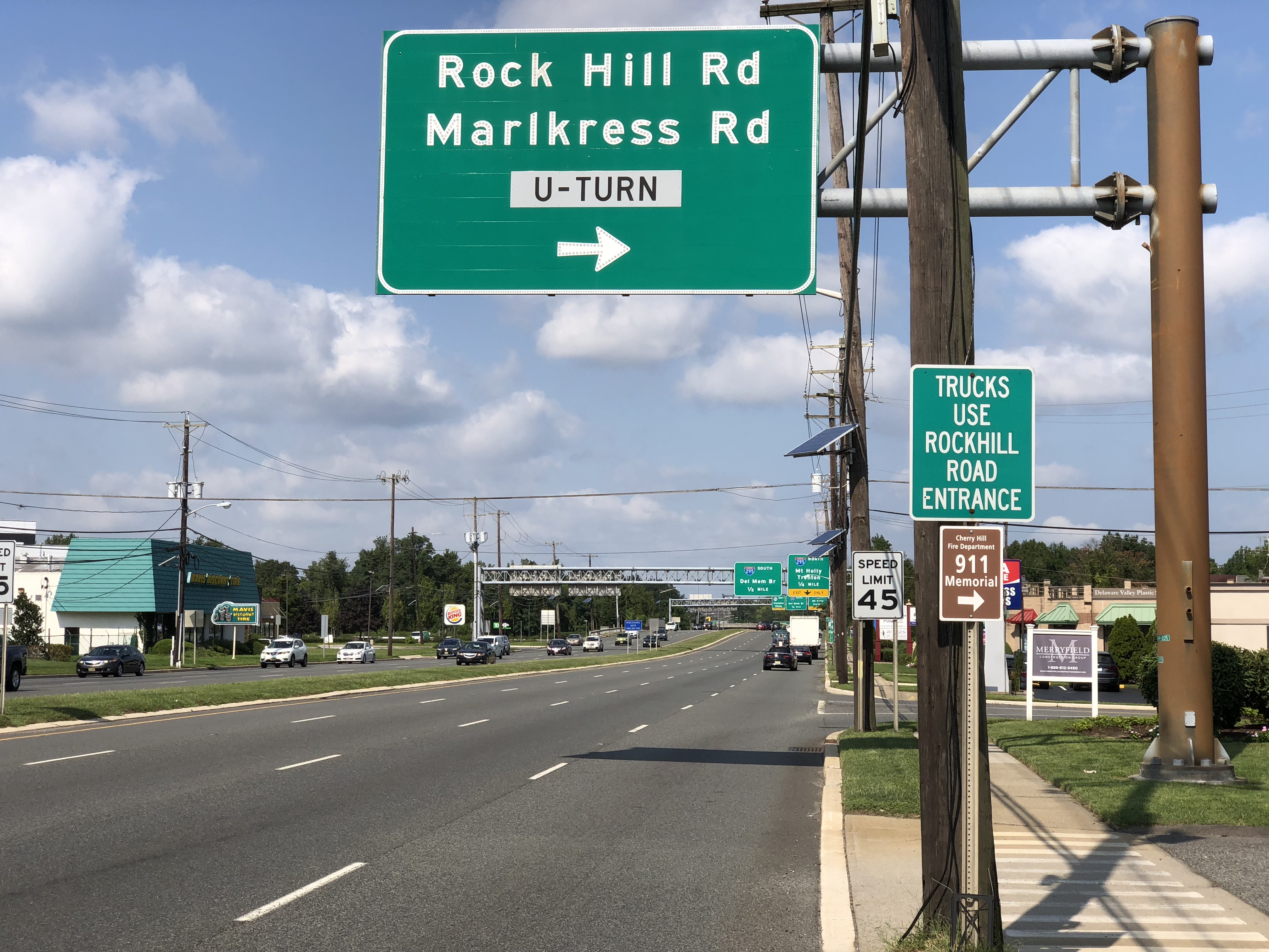 Multi-lane road with green overhead directional signs in Cherry Hill, New Jersey.
