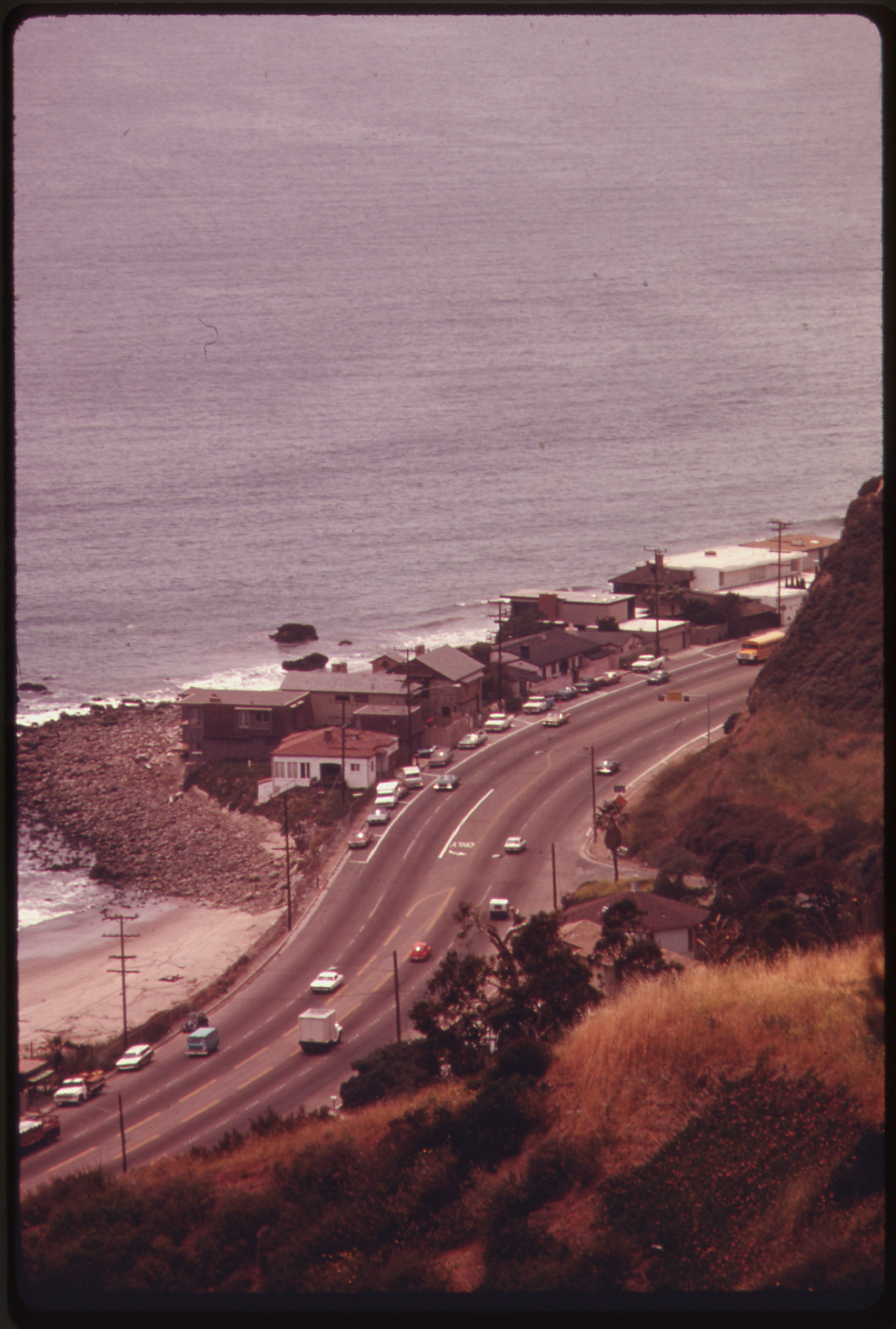 Aerial view of a coastal highway running alongside the Pacific Ocean near Malibu.