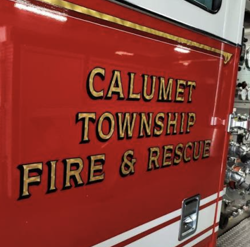 A close-up of the "Calumet Township Fire & Rescue" lettering on the side of one of the department's fire trucks.