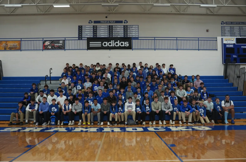 A large group of Catholic Central students and their younger brothers pose together in the school gymnasium during Brothers Day.