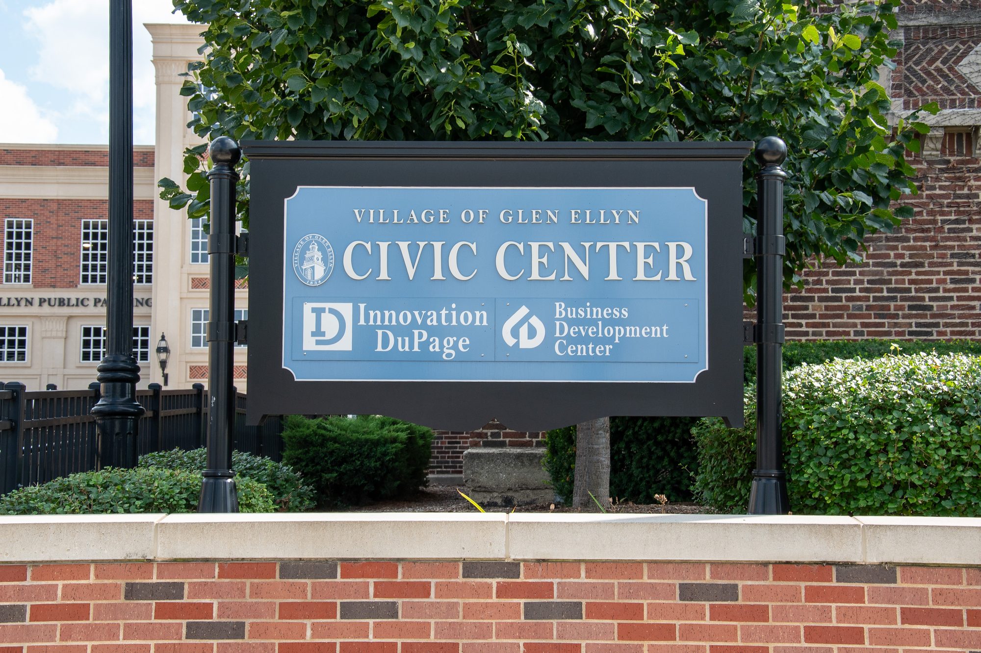 Outdoor monument sign for the Village of Glen Ellyn Civic Center on a brick base.