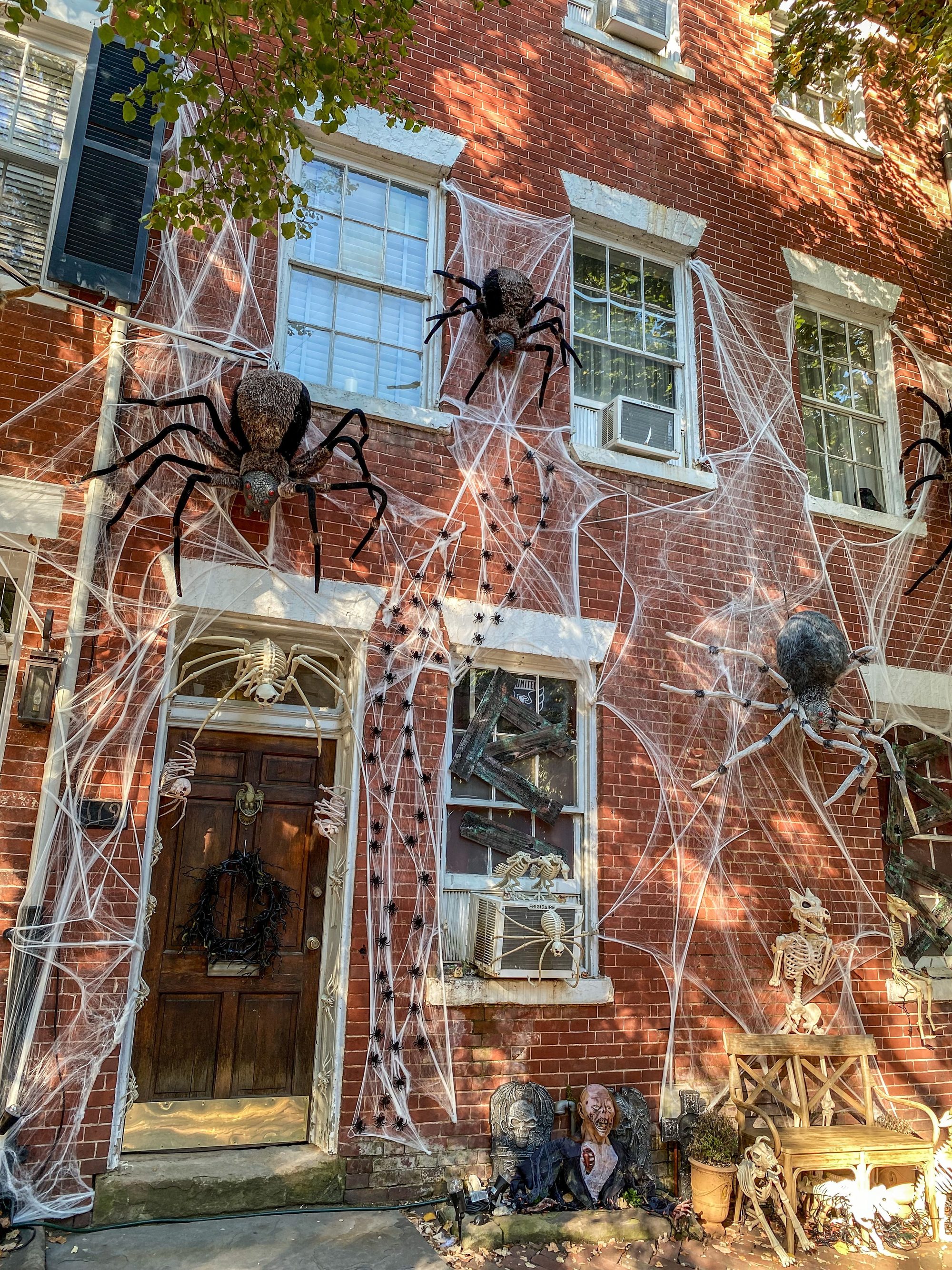 Haunted house facade with giant spiders and cobwebs. Ideal for Halloween themes.