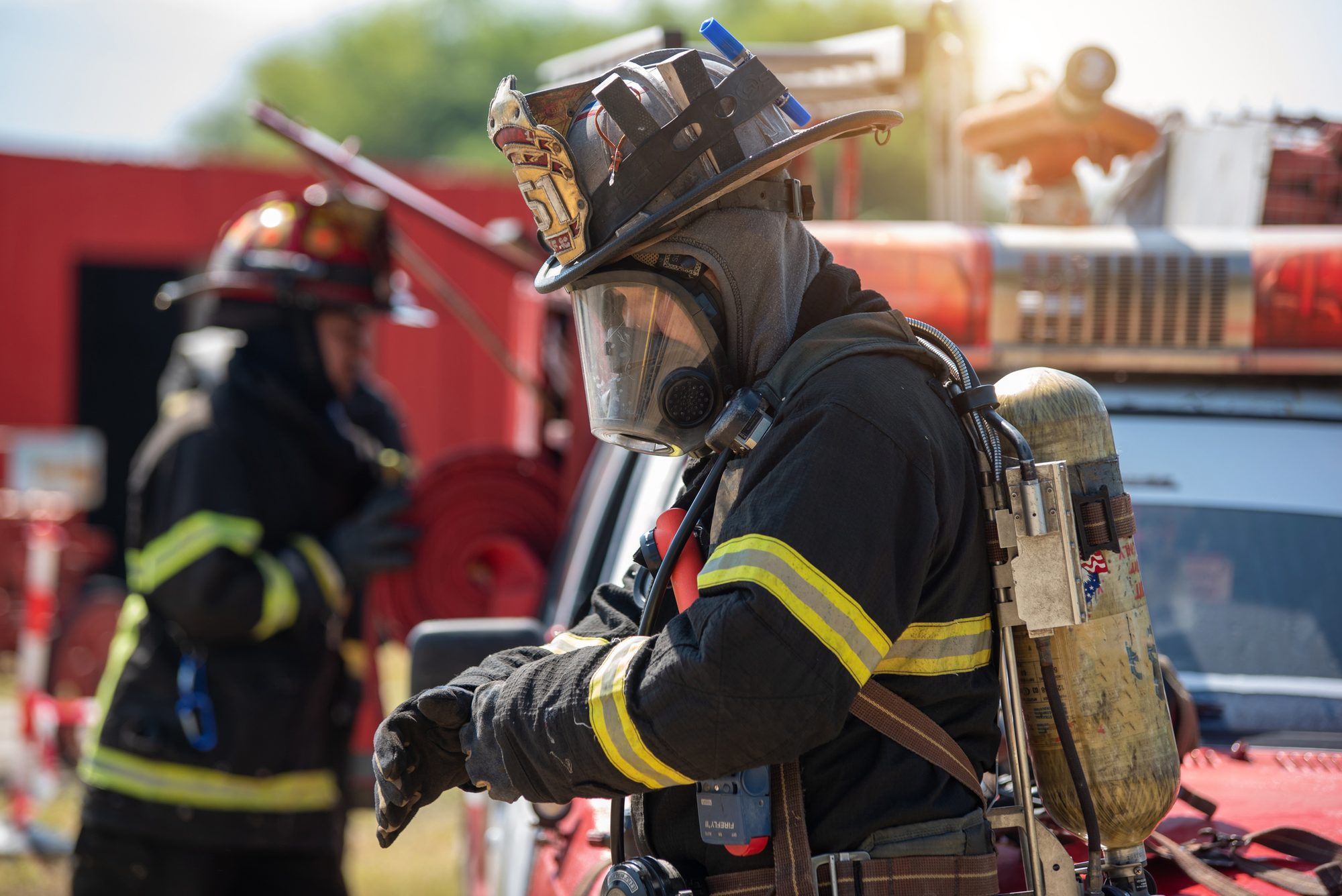 firefighters preparing and inspecting pressure and water in the fire truck inside the fire station