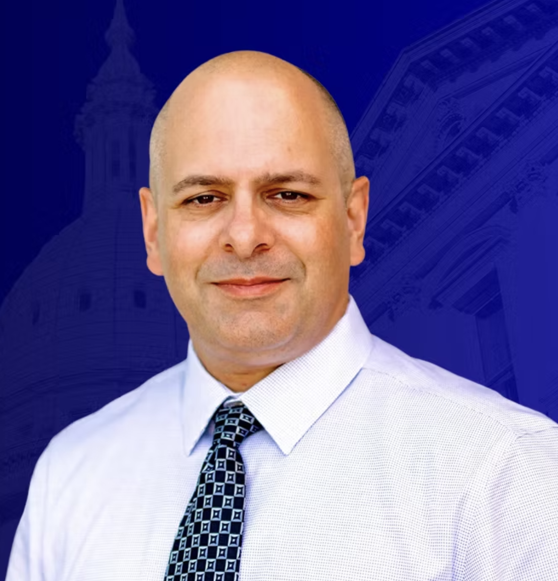 Philippe Cicchini wears a light shirt and patterned tie against a blue background featuring architectural images.