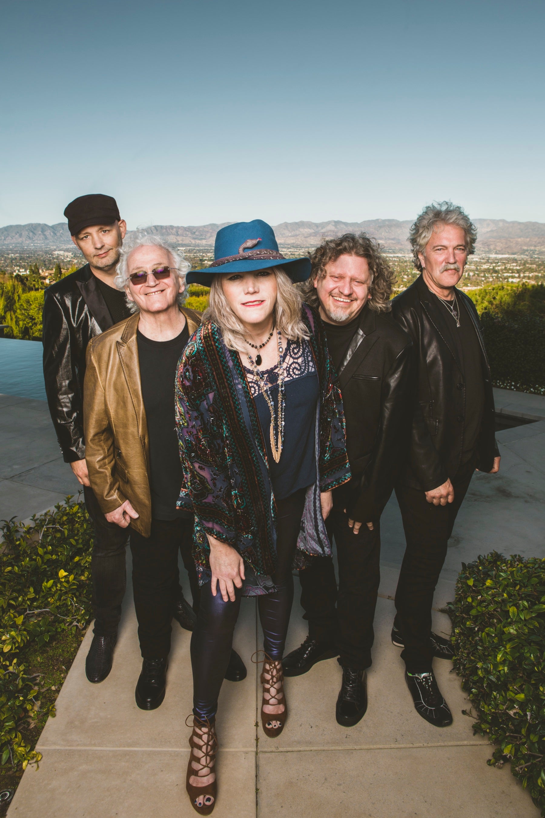 Jefferson Starship’s five band members pose outdoors in an official promotional photograph.