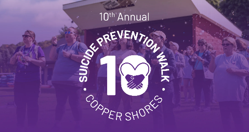 Promotional graphic for the 10th Annual Suicide Prevention Walk, showing participants in purple T-shirts walking outdoors with a purple overlay and text reading 'Suicide Prevention Walk, Copper Shores' beside a heart-in-hands icon and the number 10.
