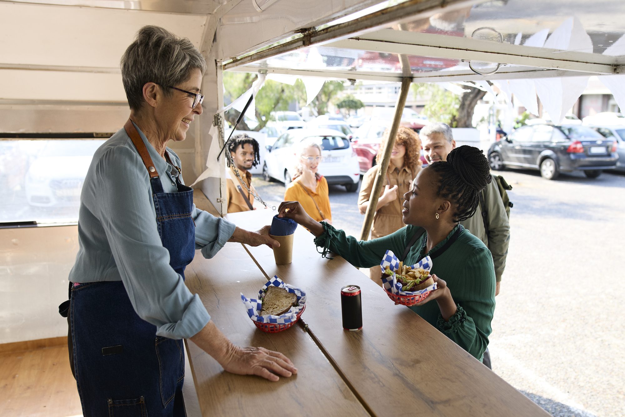 Business experts buying lunch at food truck outside office