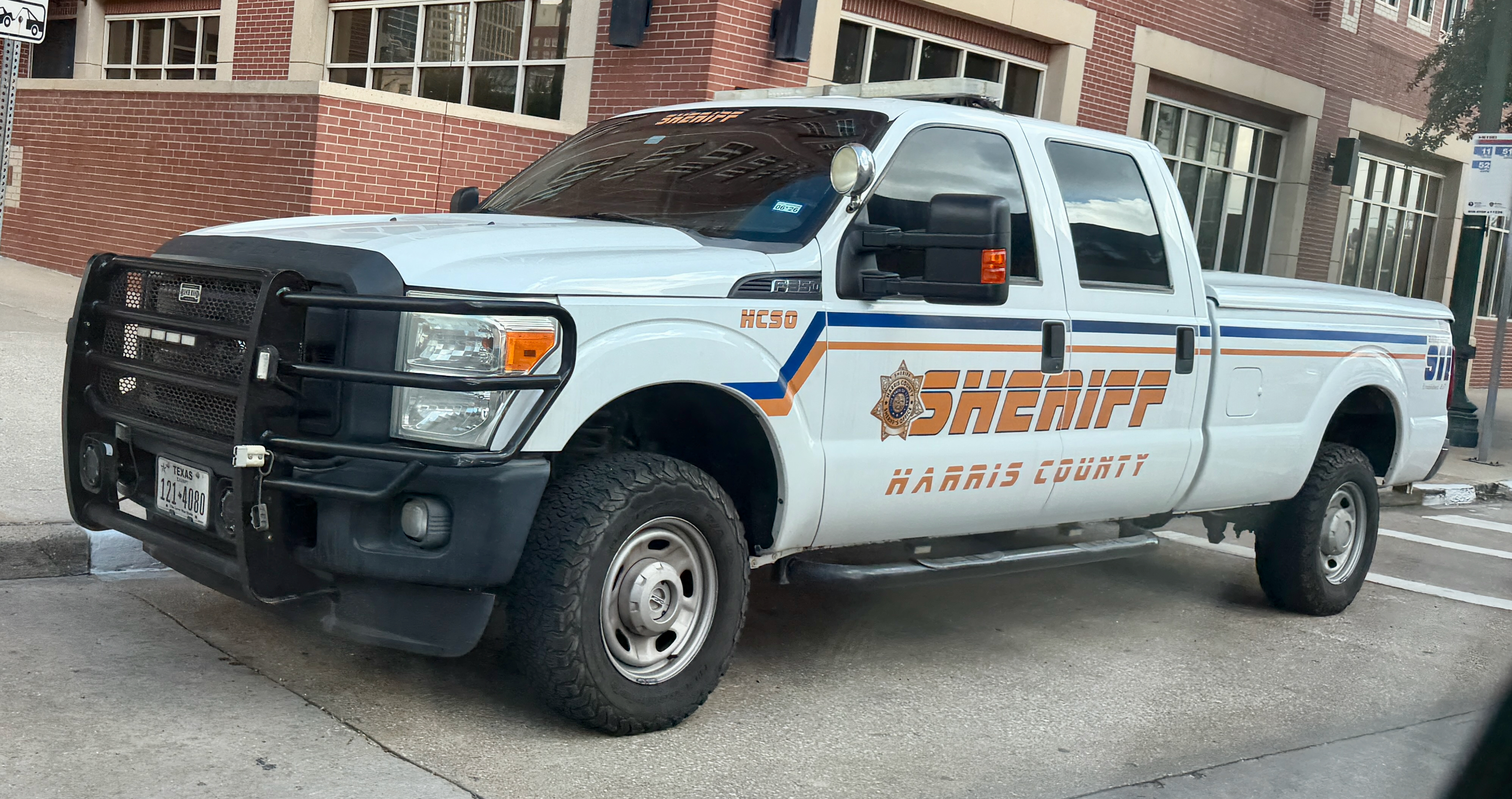 White Harris County Sheriff's Office pickup truck parked on a street.