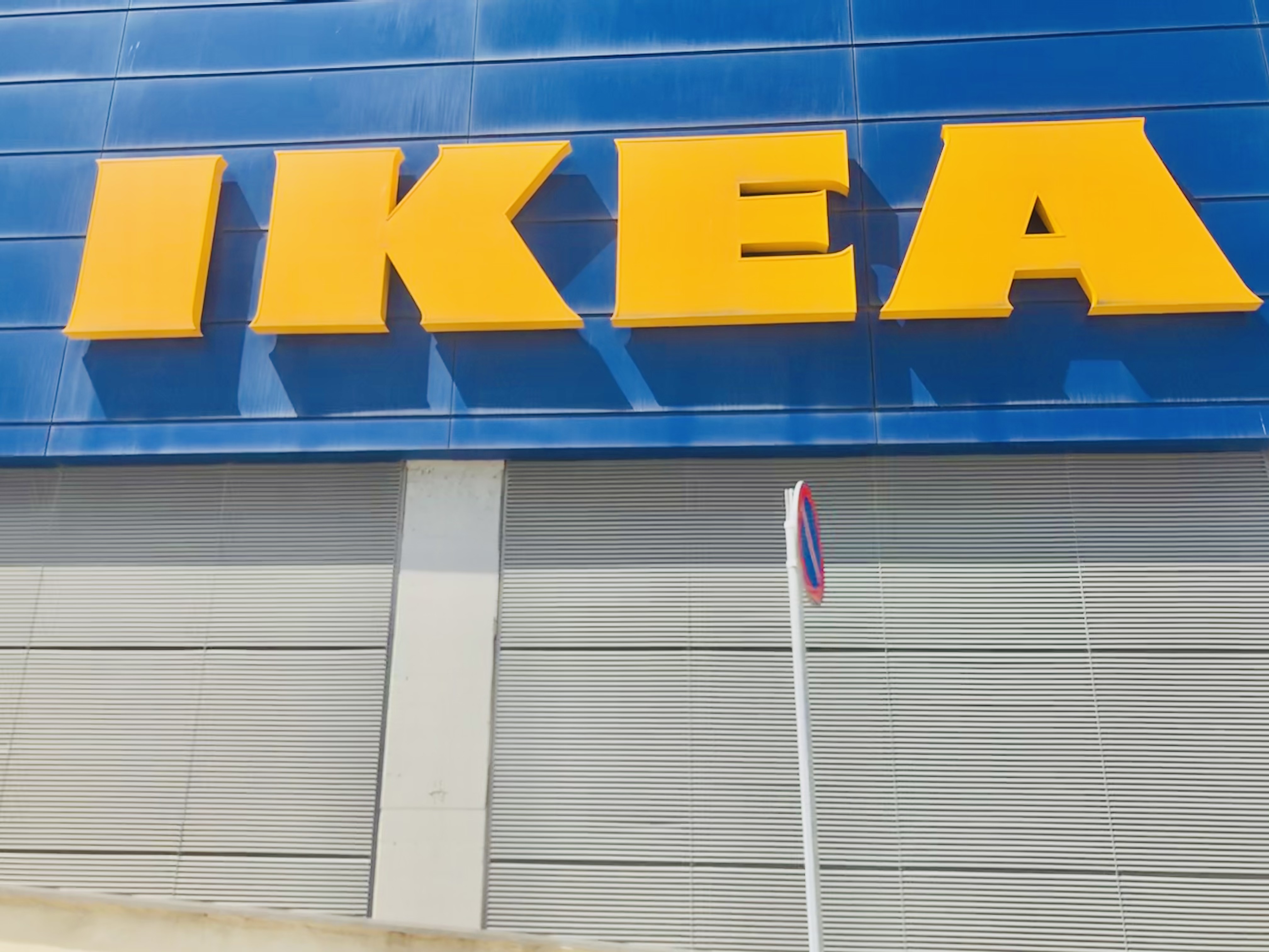 Close-up of an IKEA store facade with large yellow letters on a blue background.