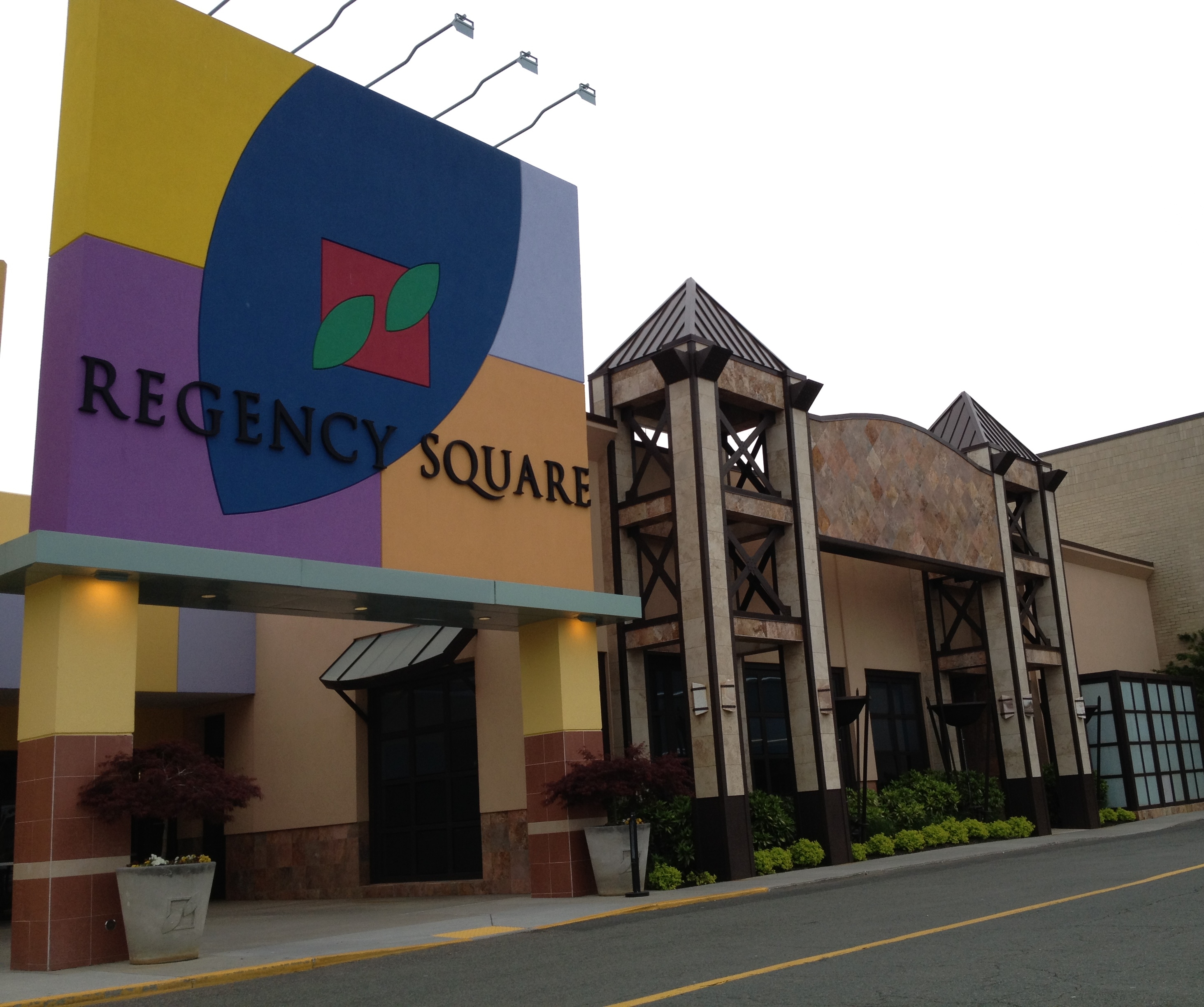 Large Regency Square Mall sign in front of the mall's entrance and facade.