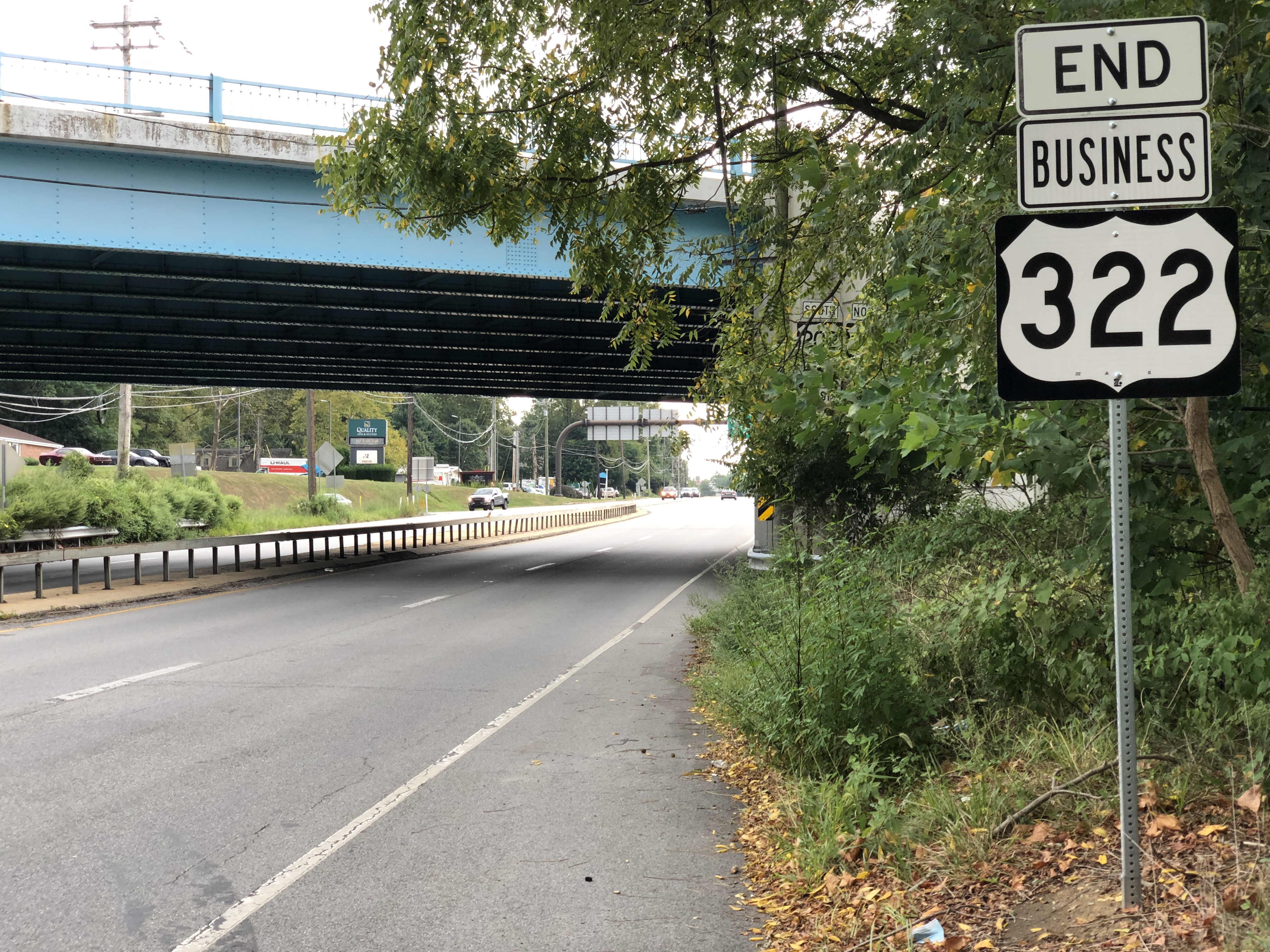 Road with an End Business 322 sign, blue overpass bridge in background.