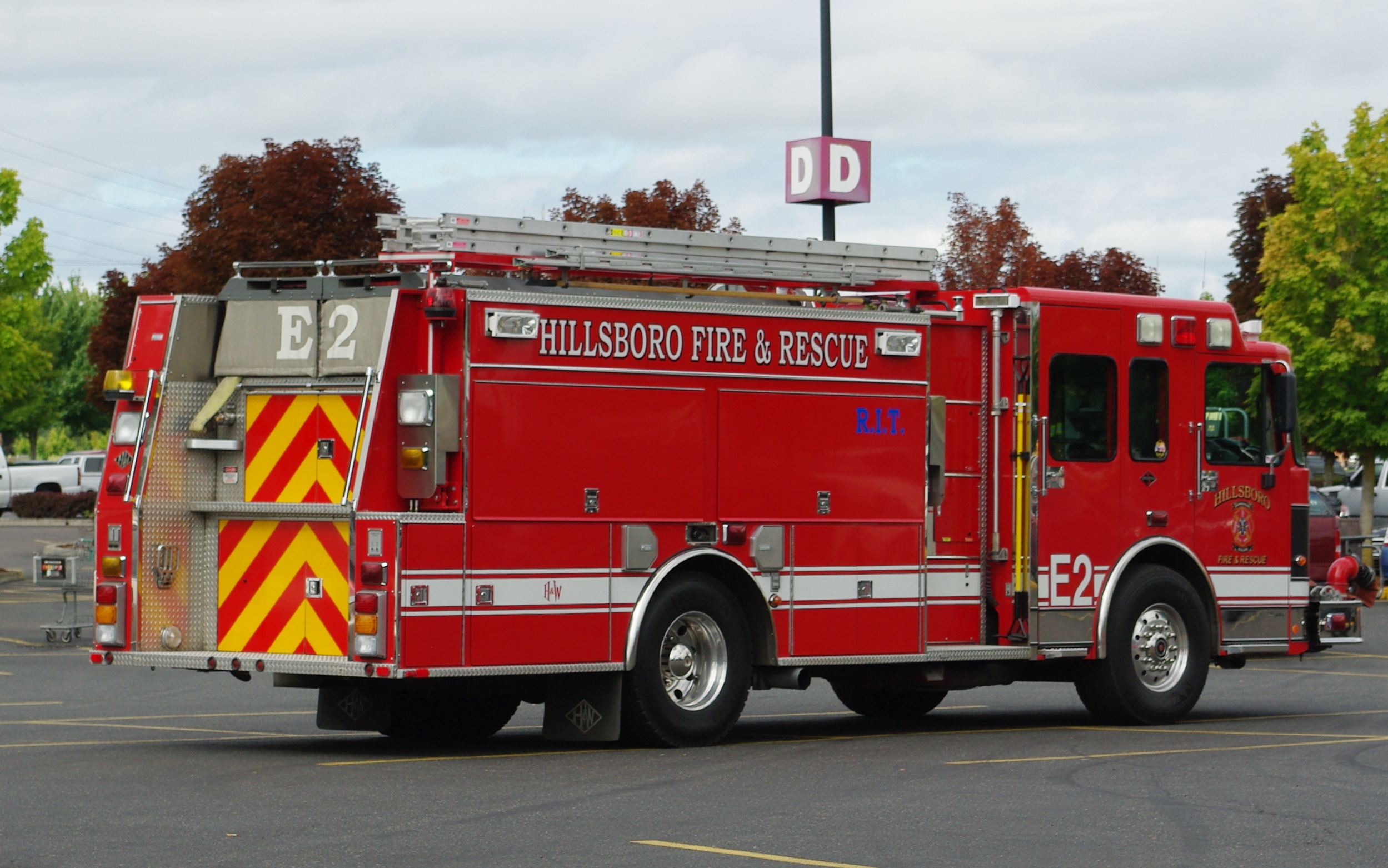 Red fire engine marked Hillsboro Fire and Rescue parked in a lot.