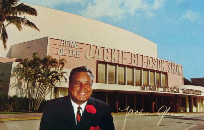 Vintage postcard of a man in a suit before a building reading 'Home of the Jackie Gleason Show.'
