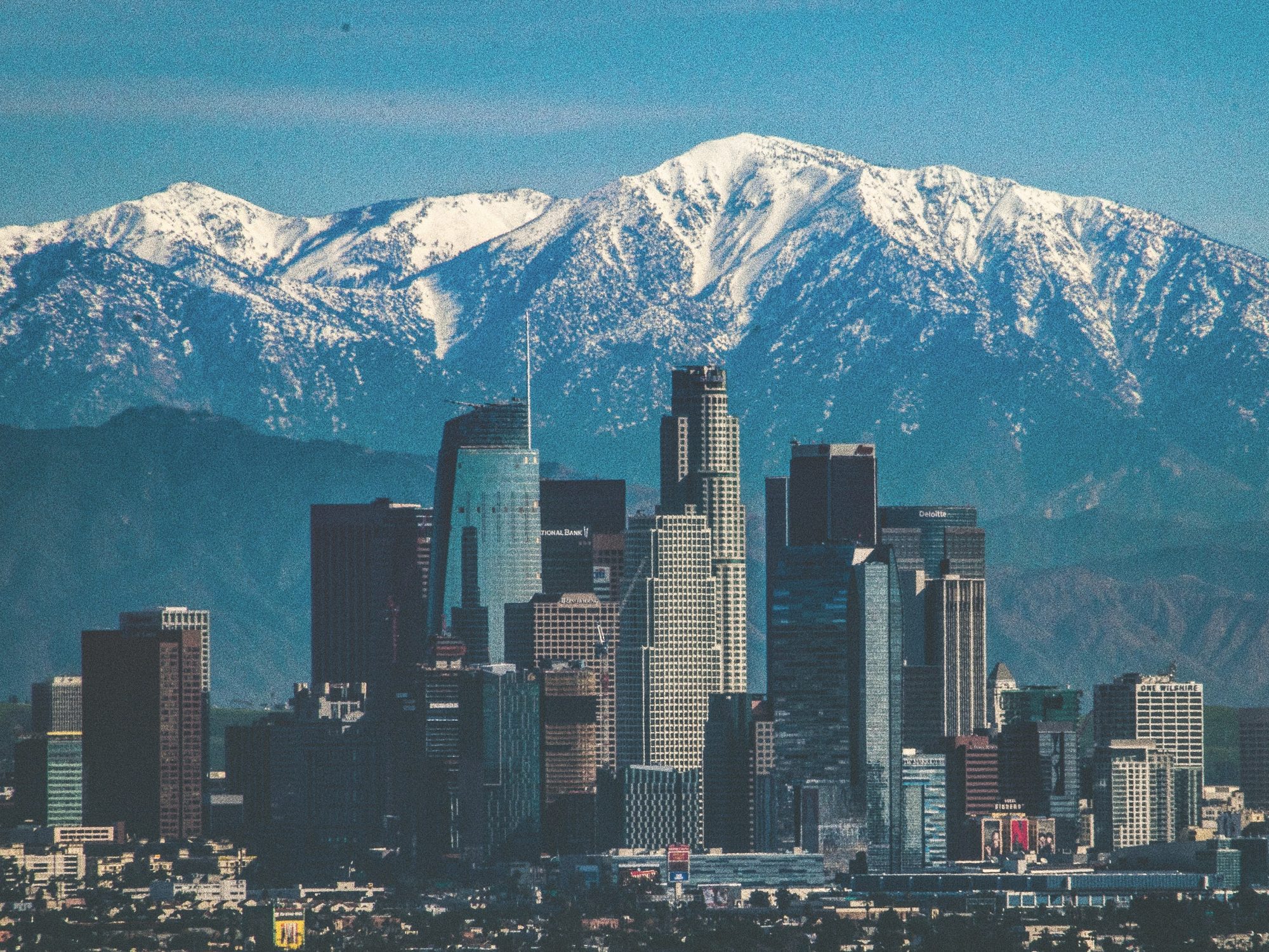 Downtown Los Angeles in winter with mountain backdrop.